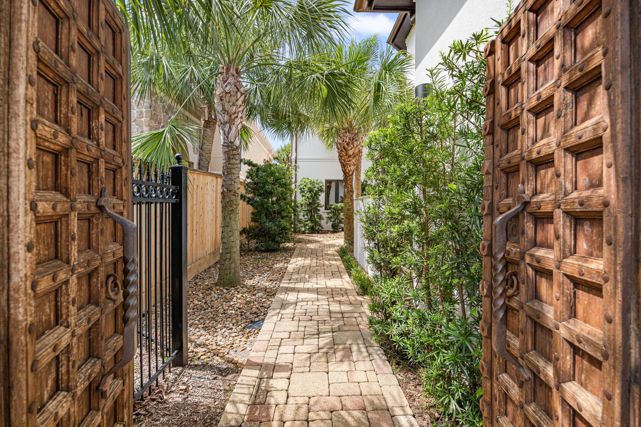 A resort-style entry welcomes you through stunning antique wood doors, setting the tone for the homes timeless elegance. A resort-style entry welcomes you through stunning antique wood doors, setting the tone for the homes timeless elegance.
