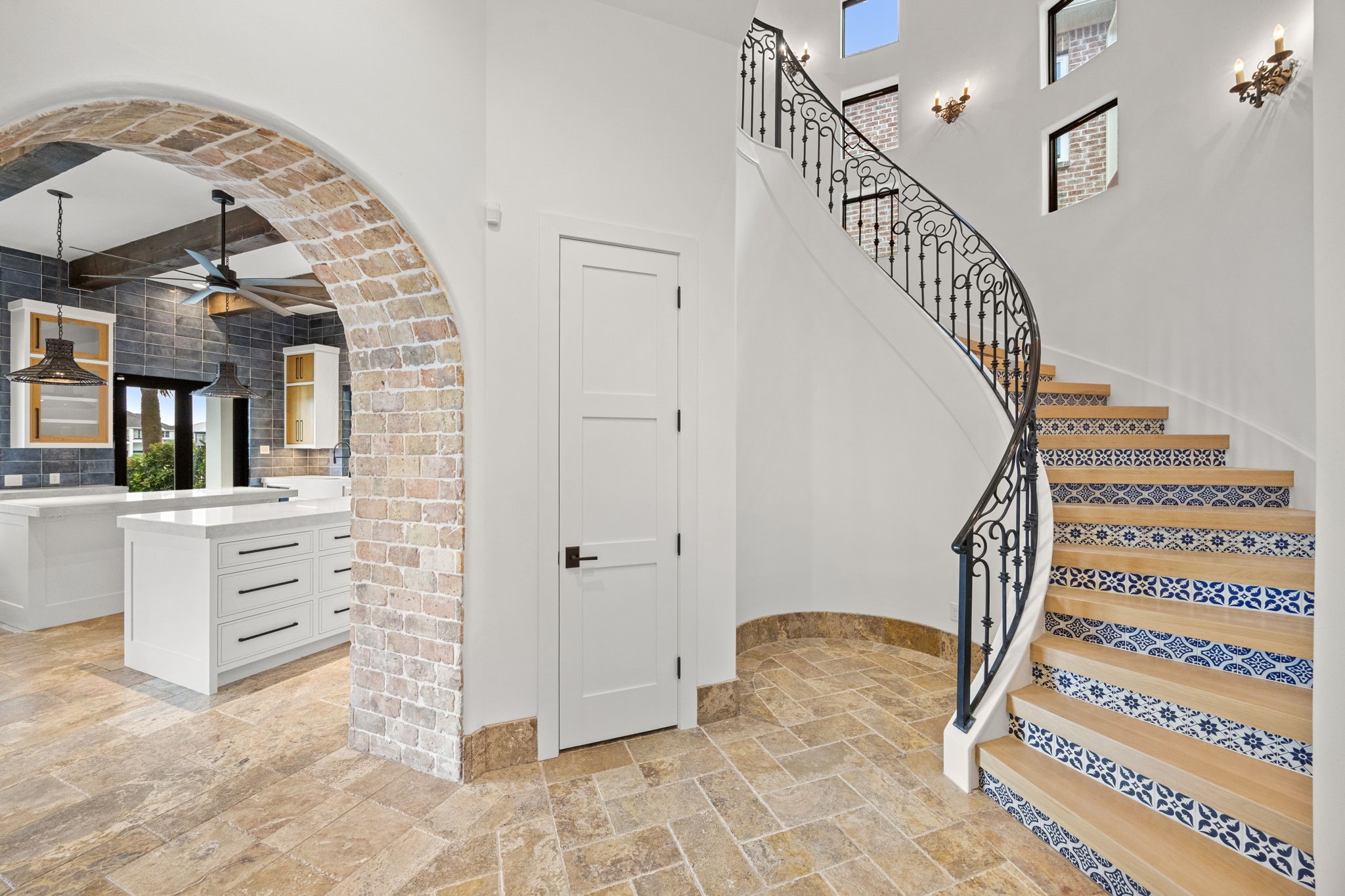 The grand staircase is a true architectural statement, featuring hand-painted Talavera tile accents and solid wood treads that showcase exceptional craftsmanship.