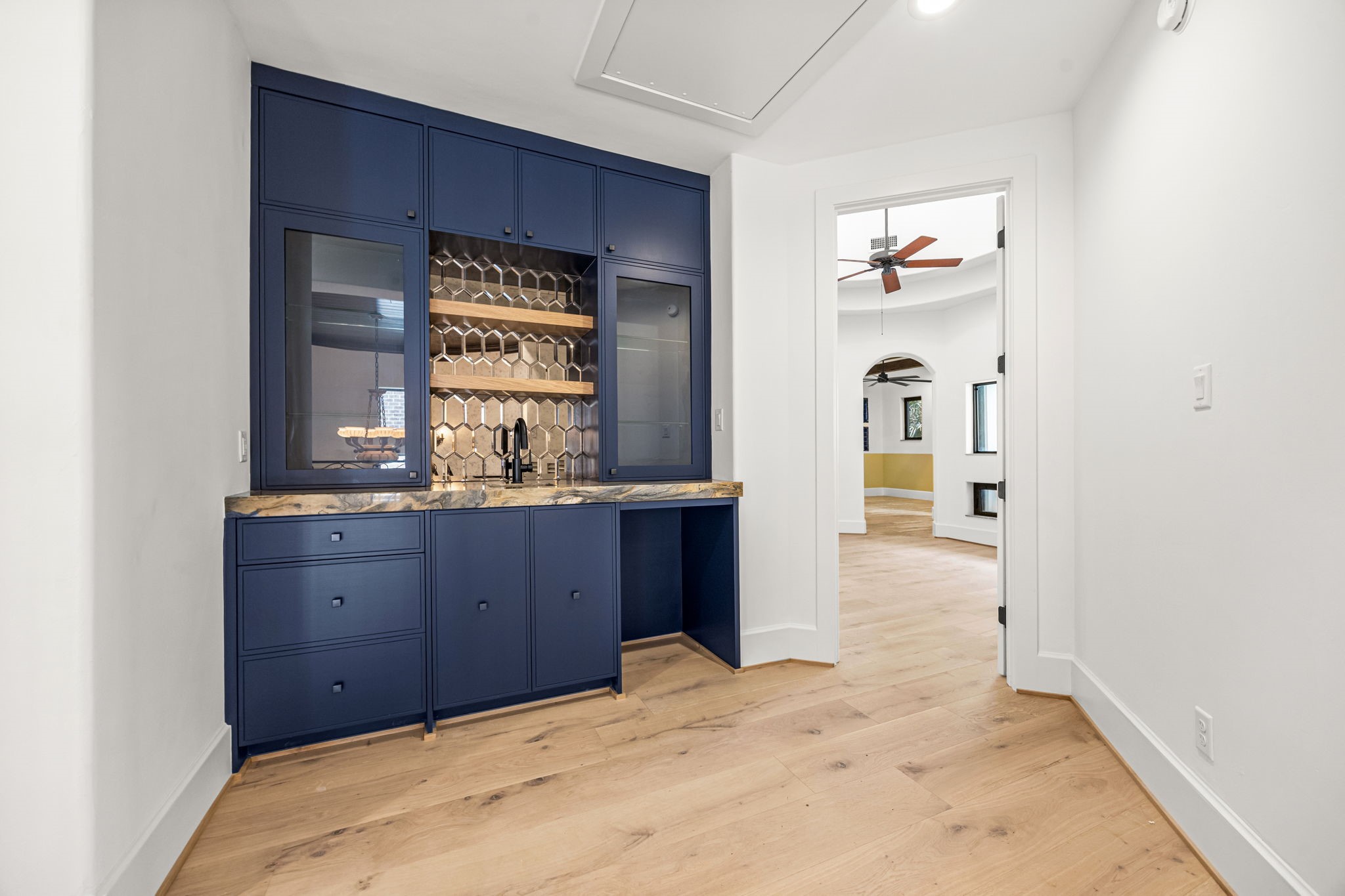 The upstairs primary suite features a convenient wet bar that can also serve as a coffee bar, perfect for morning routines or evening entertaining.