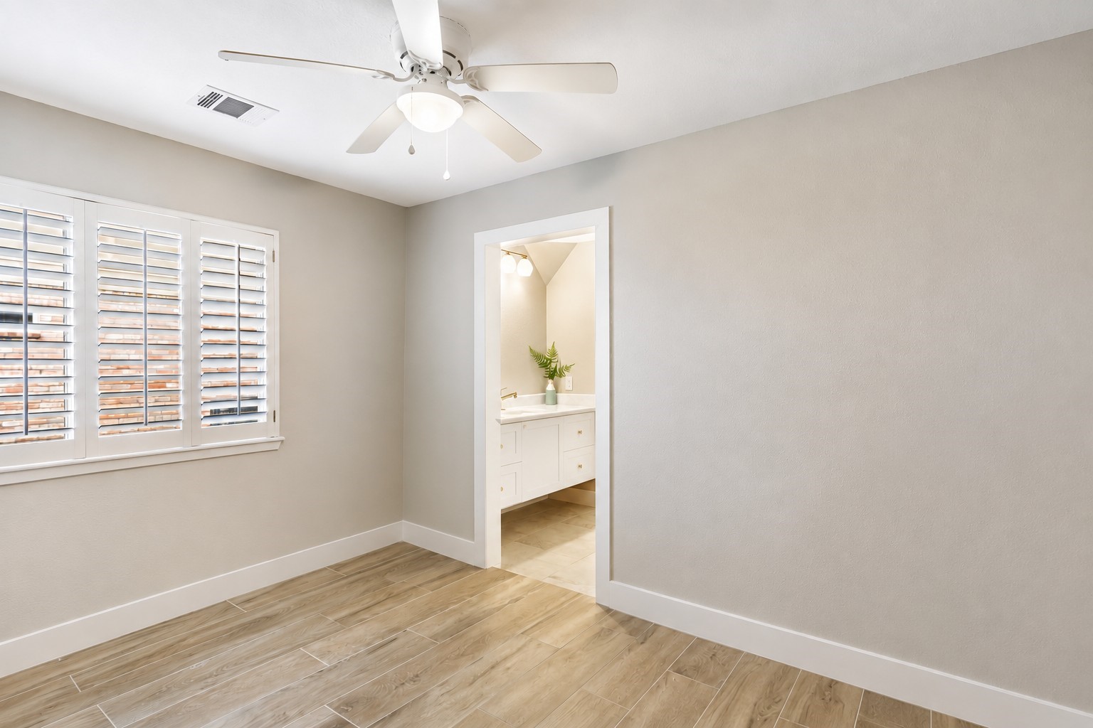 another secondary bedroom that shares a jack and jill bathroom with another bedroom.