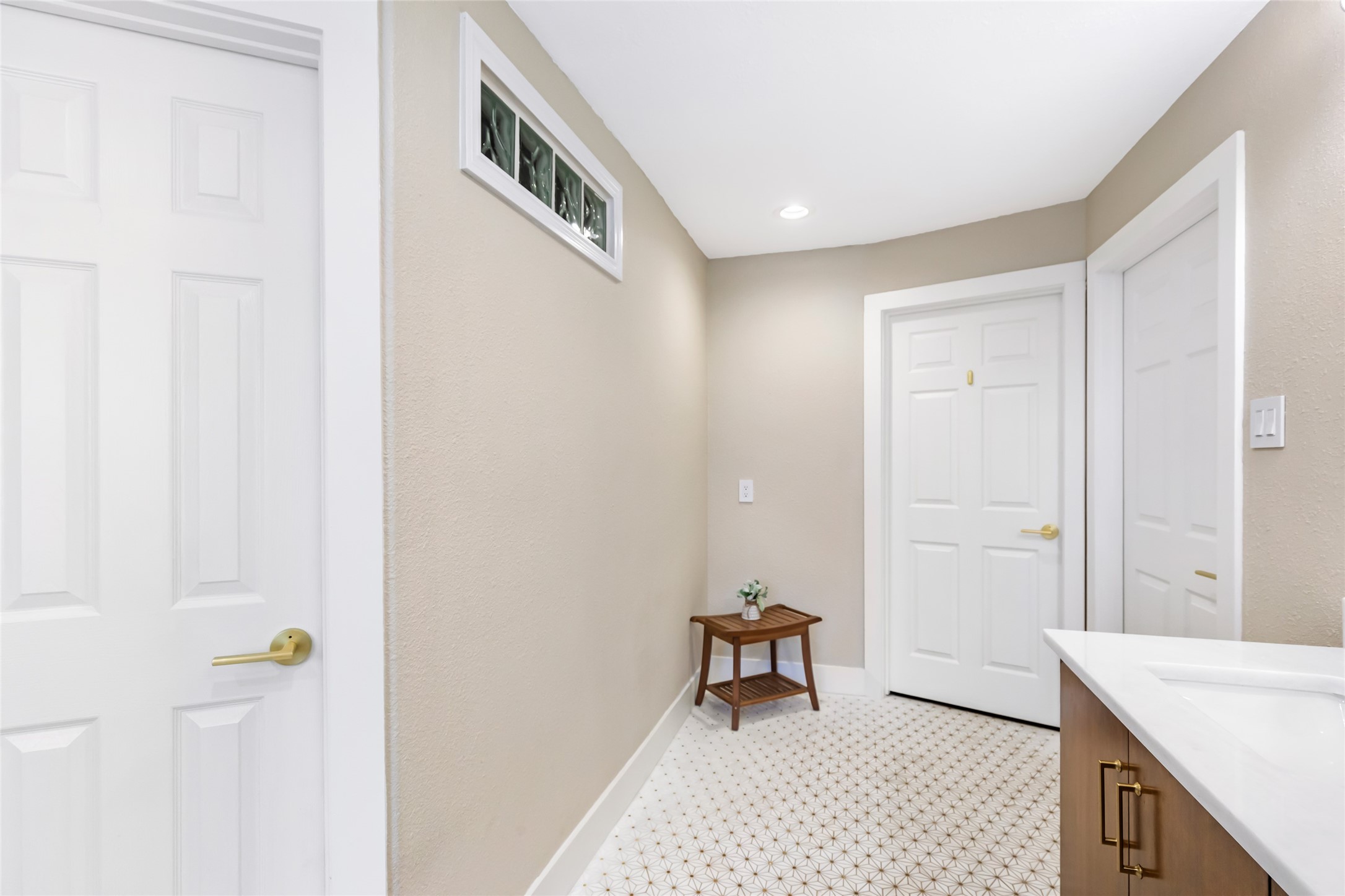 Hallway leading to the office/study/nursery  om the left and Primary bedroom straight ahead.
