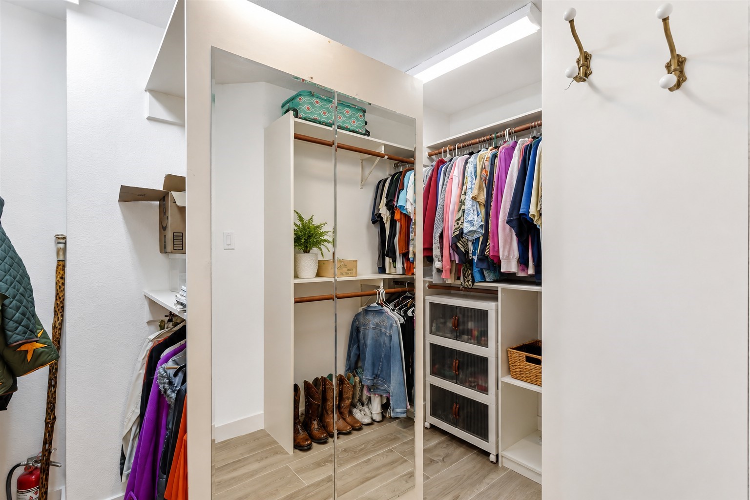 Primary bedroom closet has a pass through cabinet to conveniently throw dirty clothes directly into the washer!