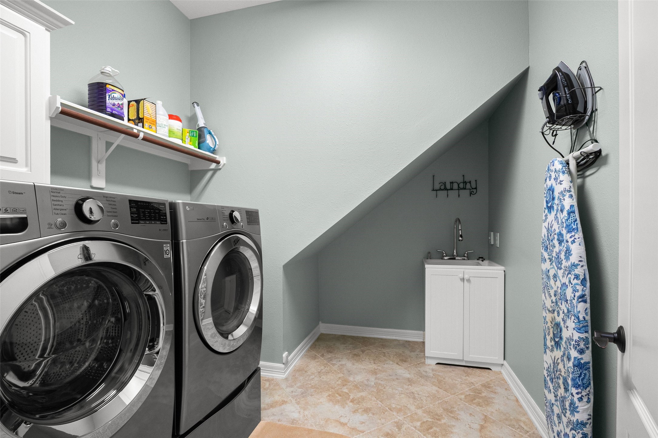 In house large laundry room with a sink