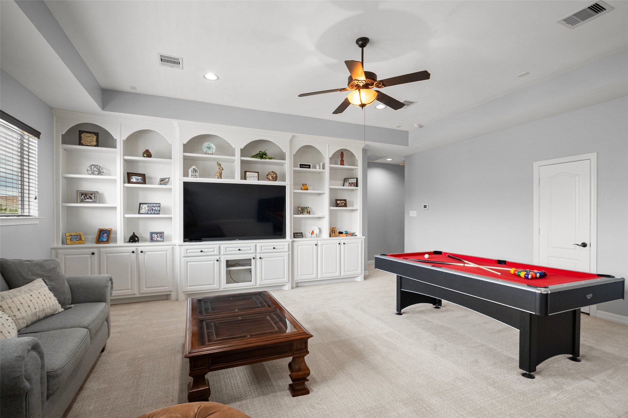 Upstairs game room large enough for a pool table, built-in entertainment center, and a sitting area.  Cozy up with a book, watch a movie  along with plenty of room for a pool table or another game table of choice.