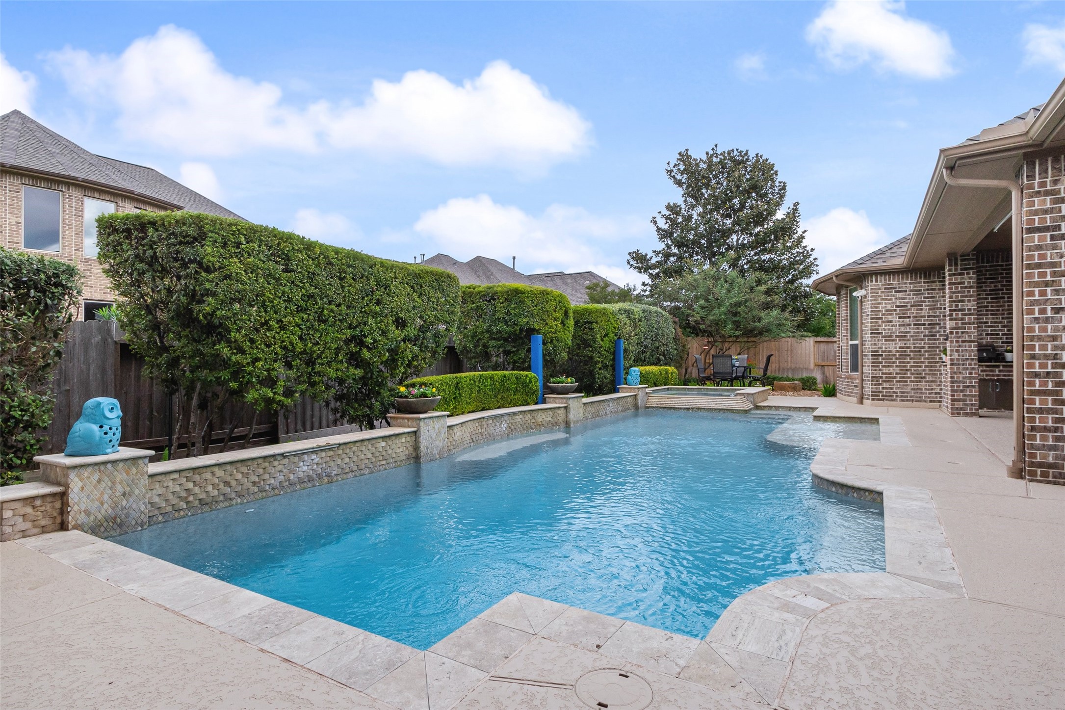 A pool is a great way to make the Texas summers easier to deal with.  Notice the blue, short metal posts near the edge of the pool.  These posts hold an very nice, custom awning that goes over a portion of the pool to shade those who aren't wanting all the sun exposure, but want to enjoy the water.  This was an $8000. addition to the pool that the sellers have really enjoyed.