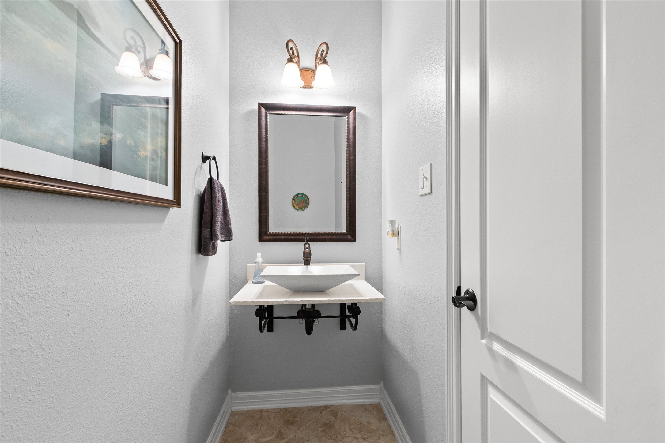 1/2 bath for guests has a lovely vessel sink.  It is located downstairs near the entrance to the laundry room & garage.