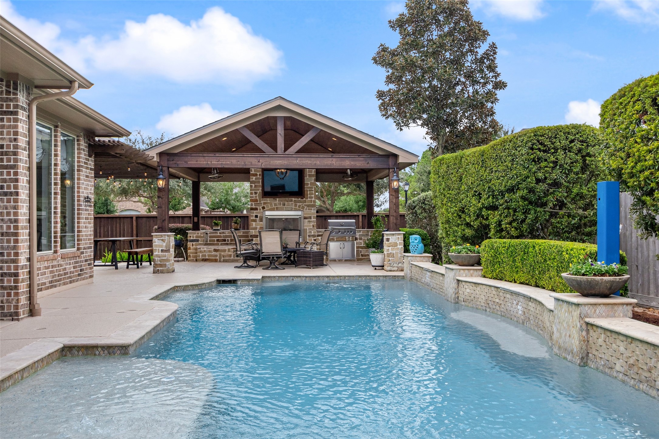 Beautiful outdoor setting.  Looking across the pool/spa is the covered pergola.