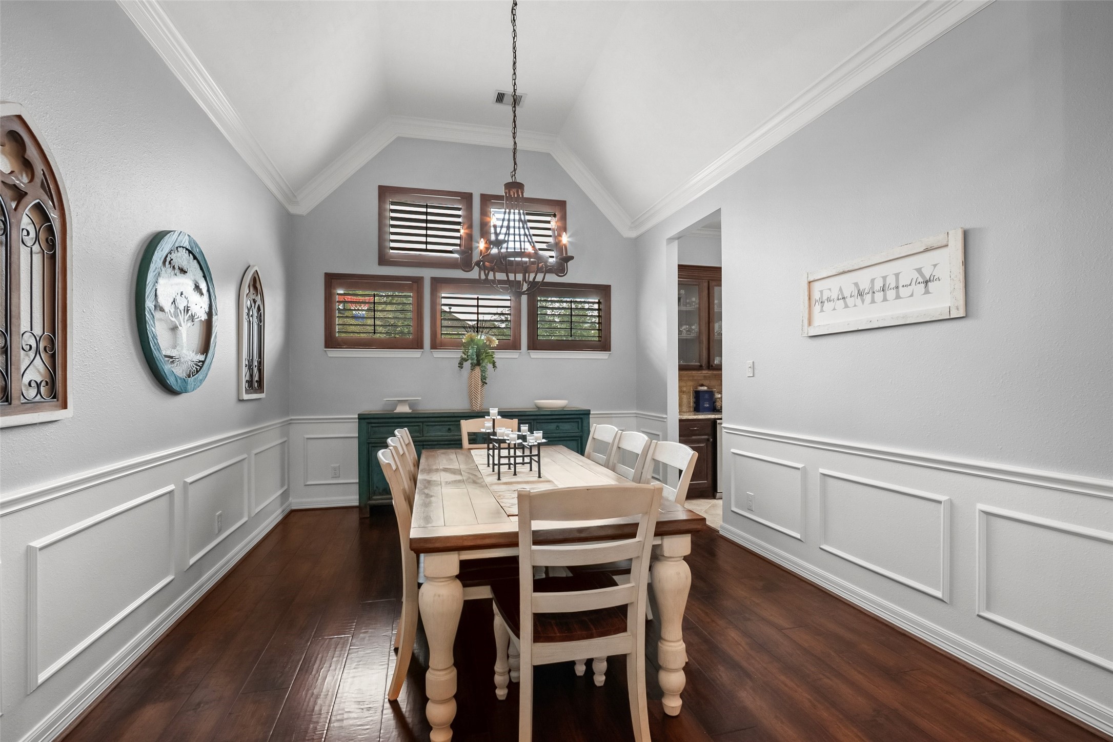 Large dining room with wood flooring, and a  coffered ceiling.