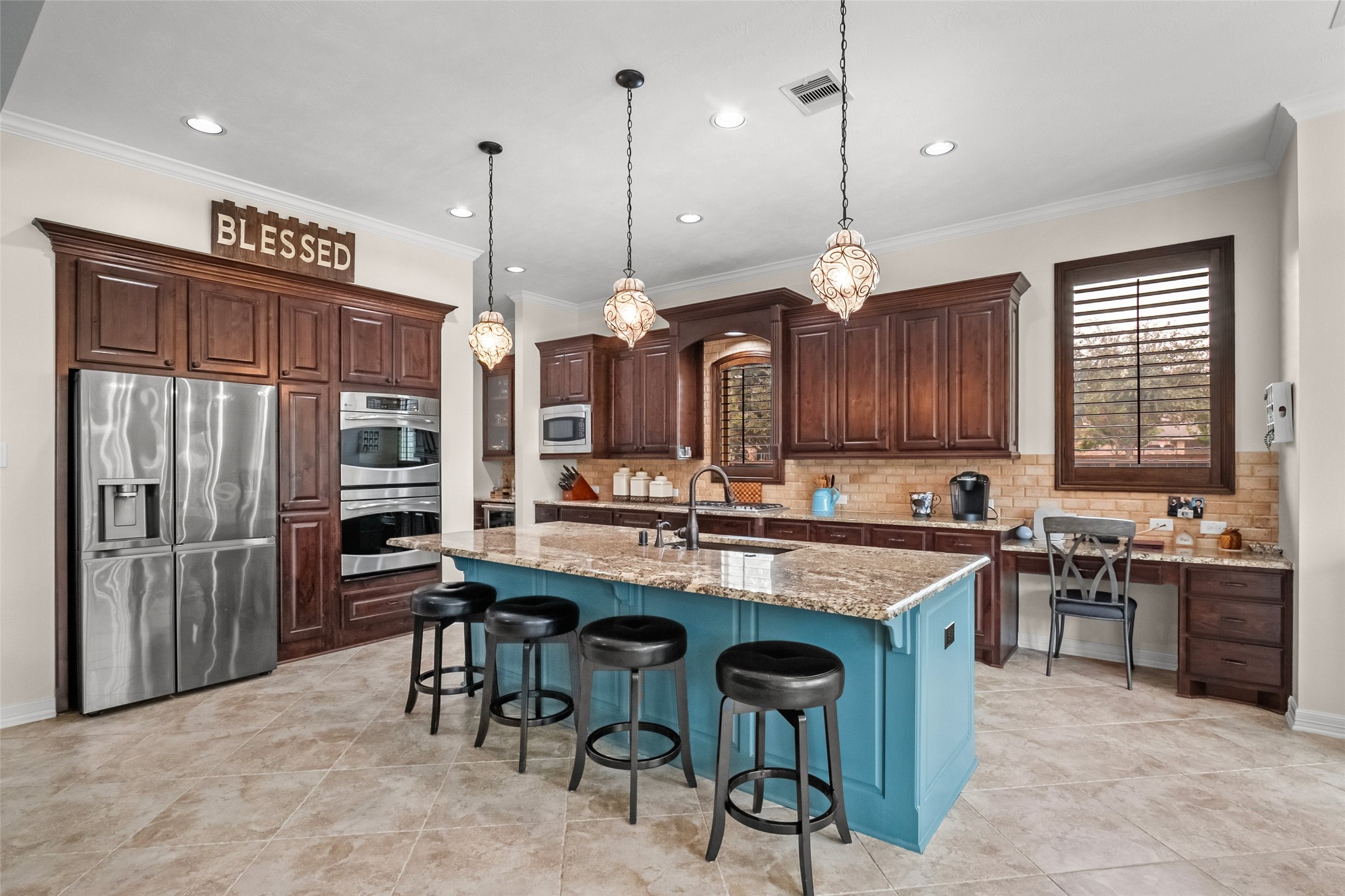 Kitchen island comfortably holds 4 barstools.  Double convection ovens, cooktop has pop-up exhaust ventilation, and there is even a chef's desk.  This desk  is a great place for a child to do homework while under a watchful eye.