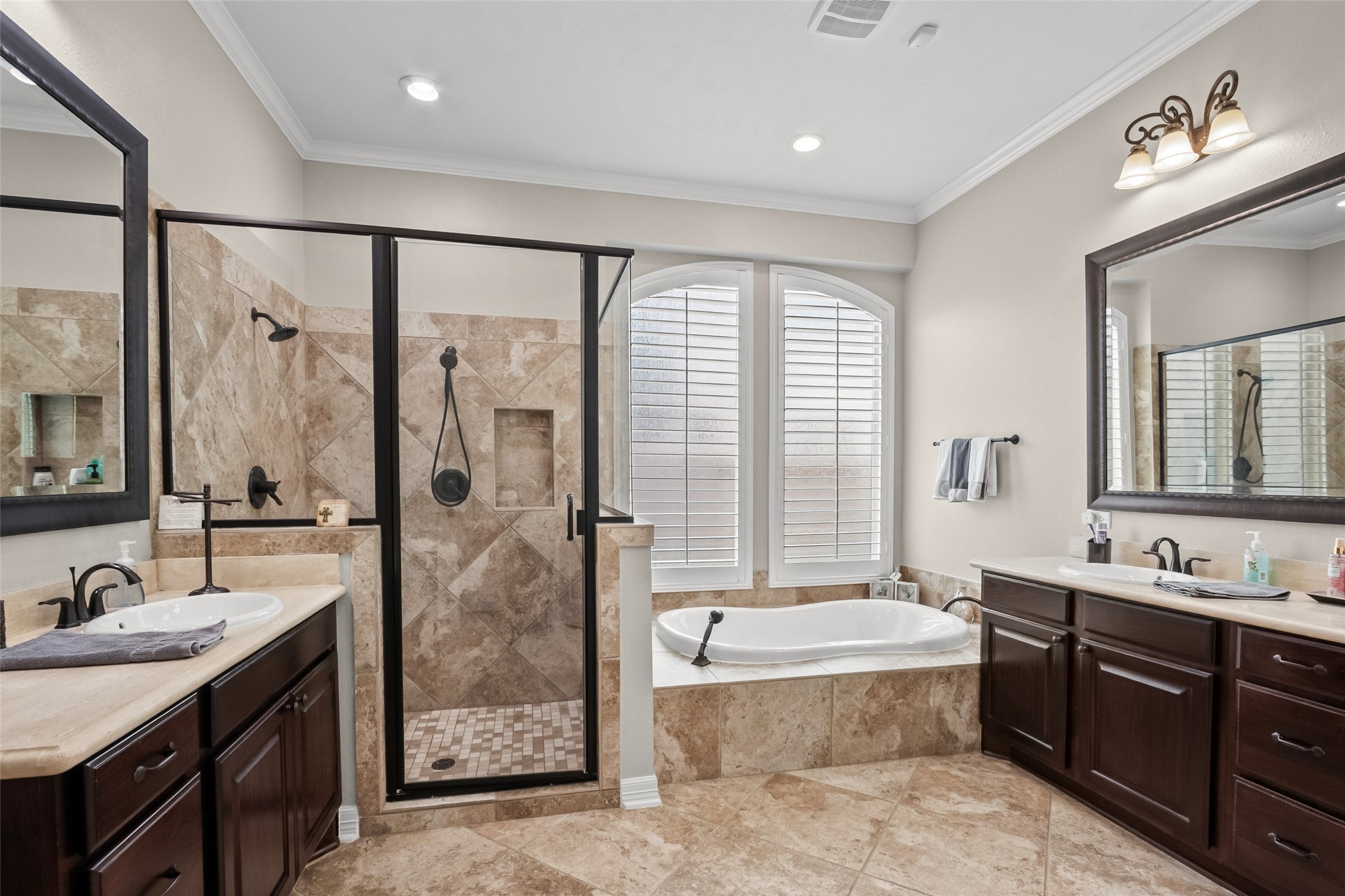 Huge primary bathroom with seperate sinks, and also has his/hers closets.