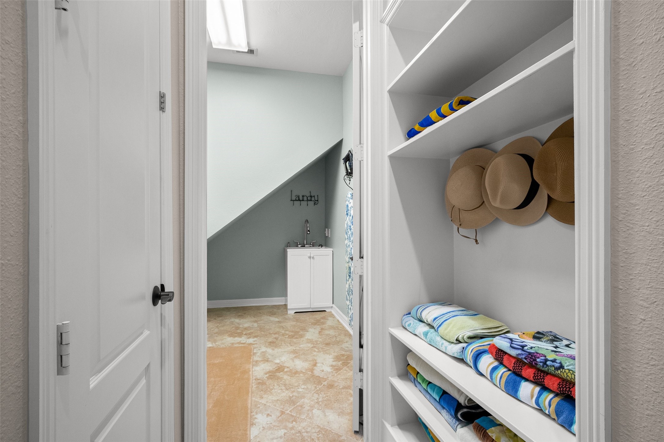 Mud room sits just outside the laundry room, and currently used for pool towels/hats.