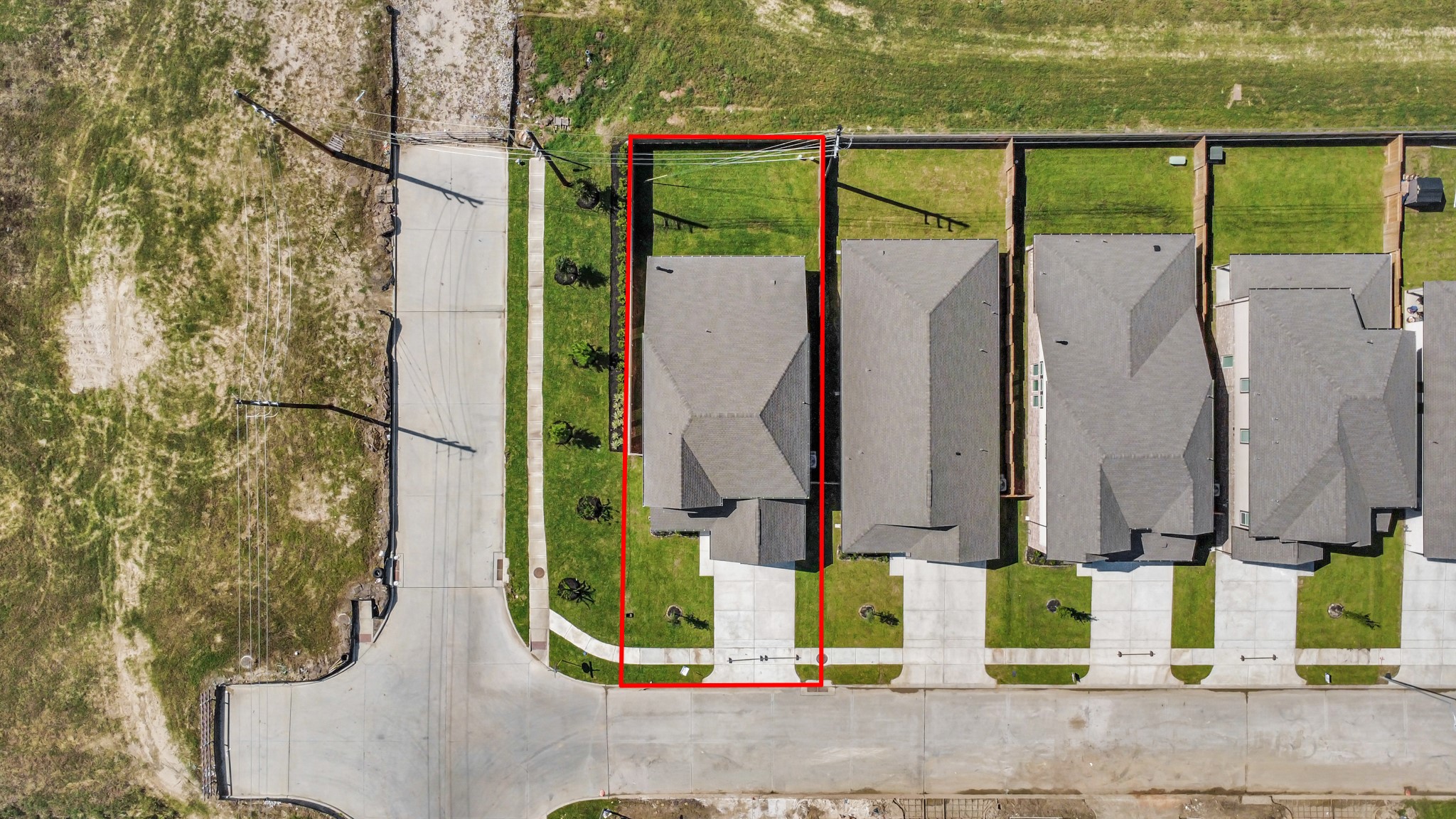 An aerial view of a spacious subdivision lot, highlighting a well-maintained yard and a fully fenced perimeter, offering both privacy and expansive outdoor space.