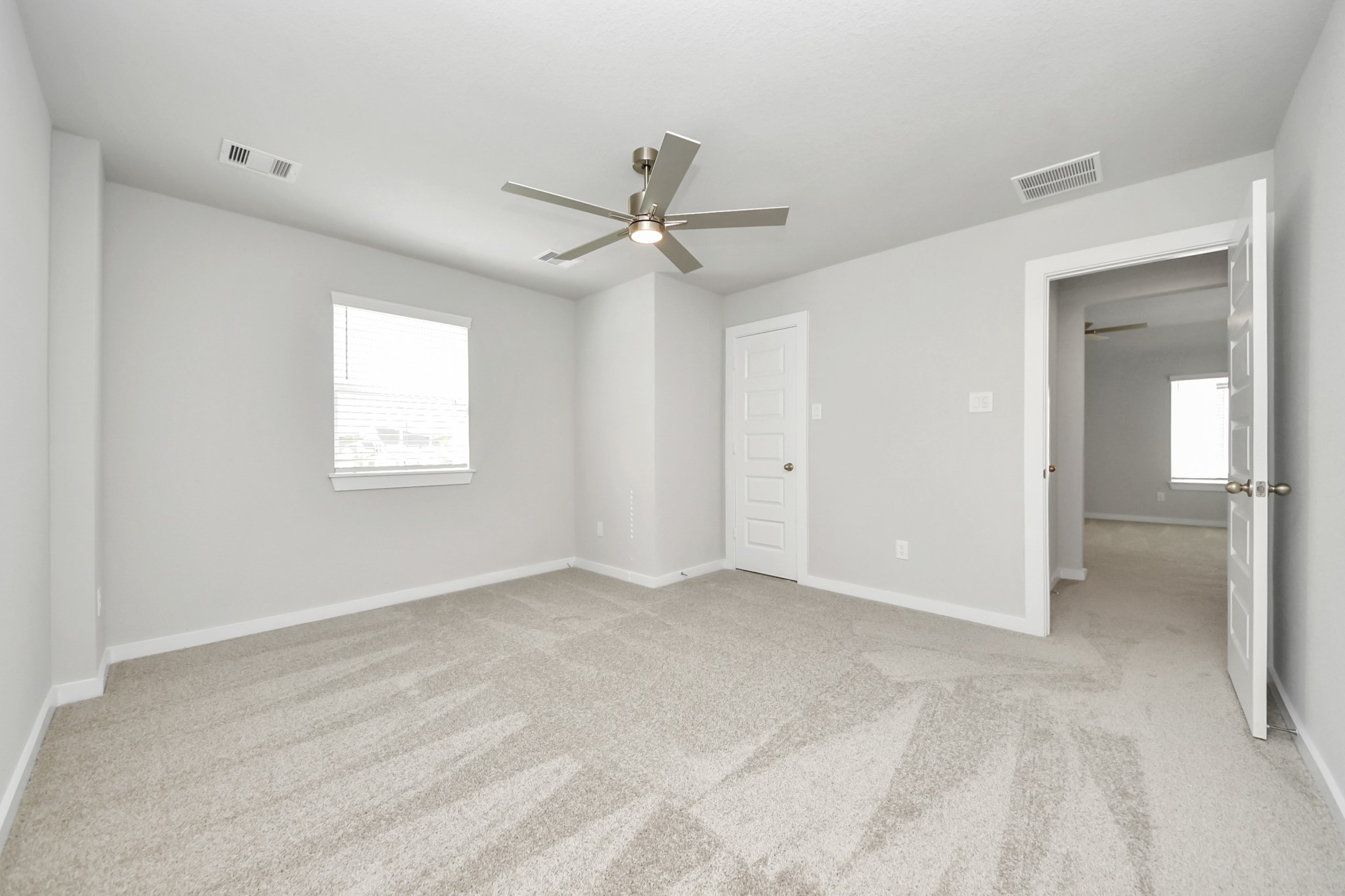 Generously sized secondary bedrooms featuring spacious closets, soft and inviting carpeting underfoot, large windows allowing plenty of natural light, and the added touch of privacy blinds for your personal retreat. Sample photo of completed home with similar floor plan. Actual colors and selections may vary.