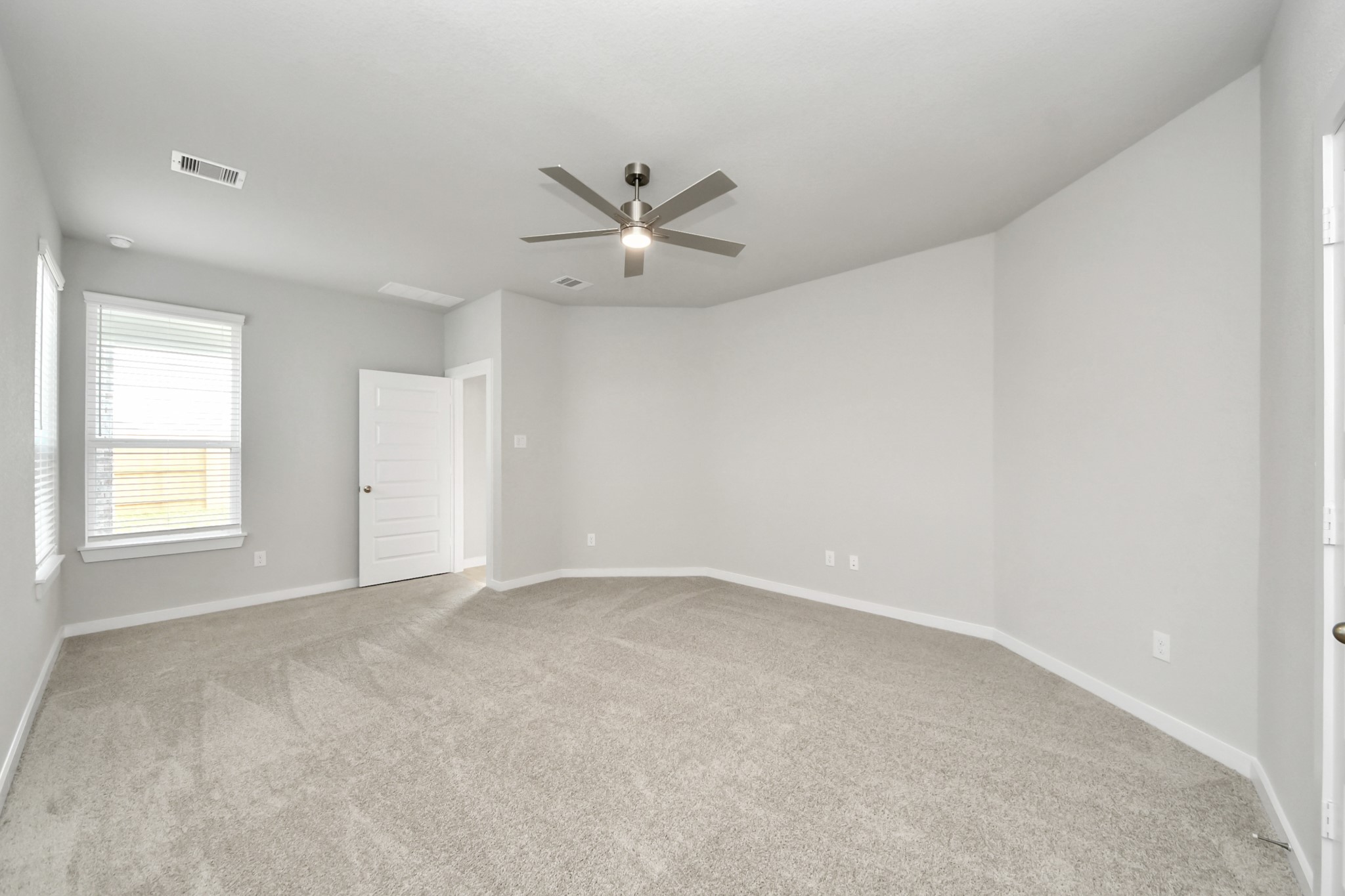 Come and unwind after a long day in this magnificent primary suite! This spacious room features plush carpet, warm paint, high ceilings and large windows with privacy blinds. Sample photo of completed home with similar floor plan. Actual colors and selections may vary.