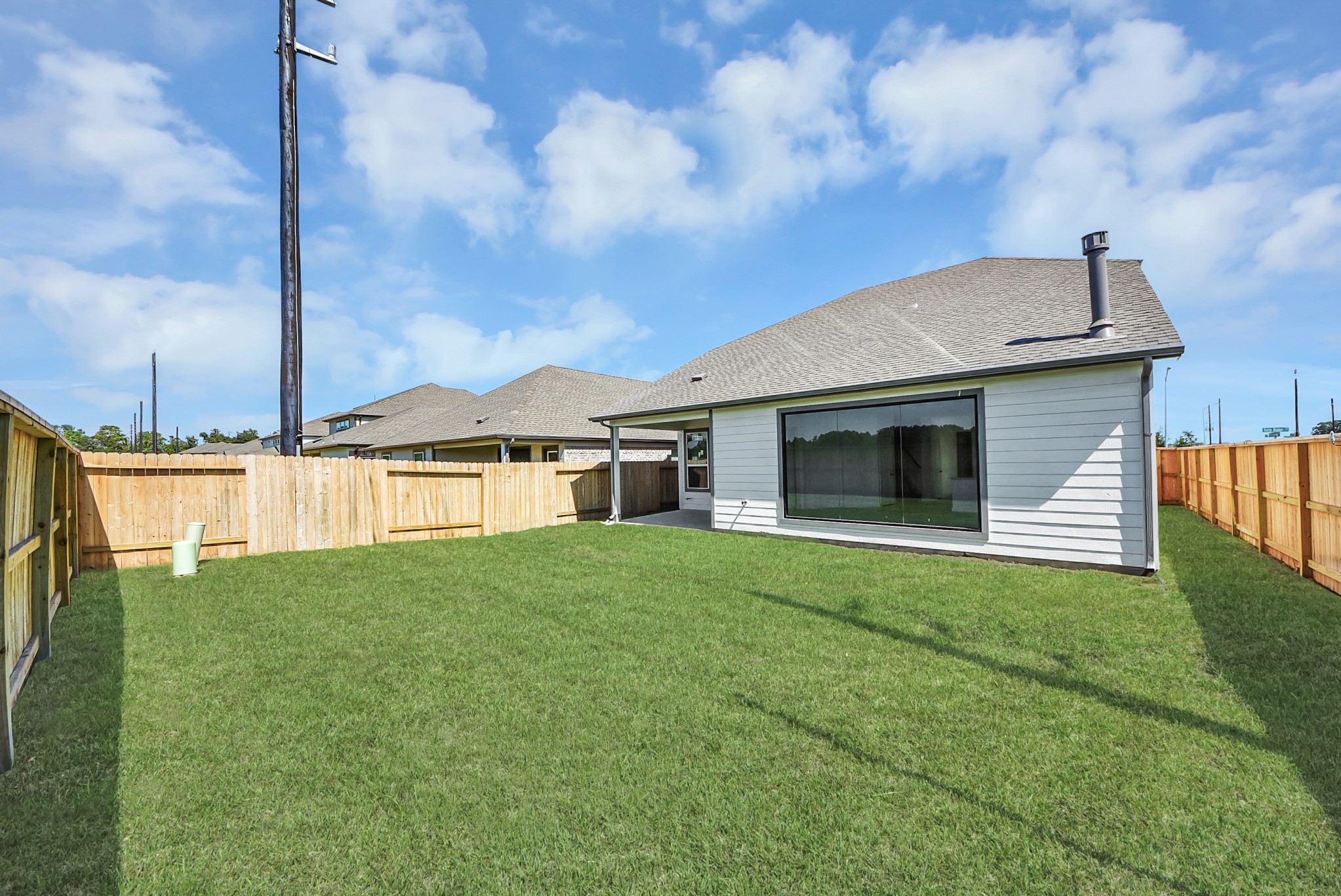 Come and see this spacious backyard with its beautiful covered patio. There is plenty of room for the kids to play and adults to relax. Perfect for your outdoor living space, patio furniture, bbq pit, and so much more. The possibilities are endless!