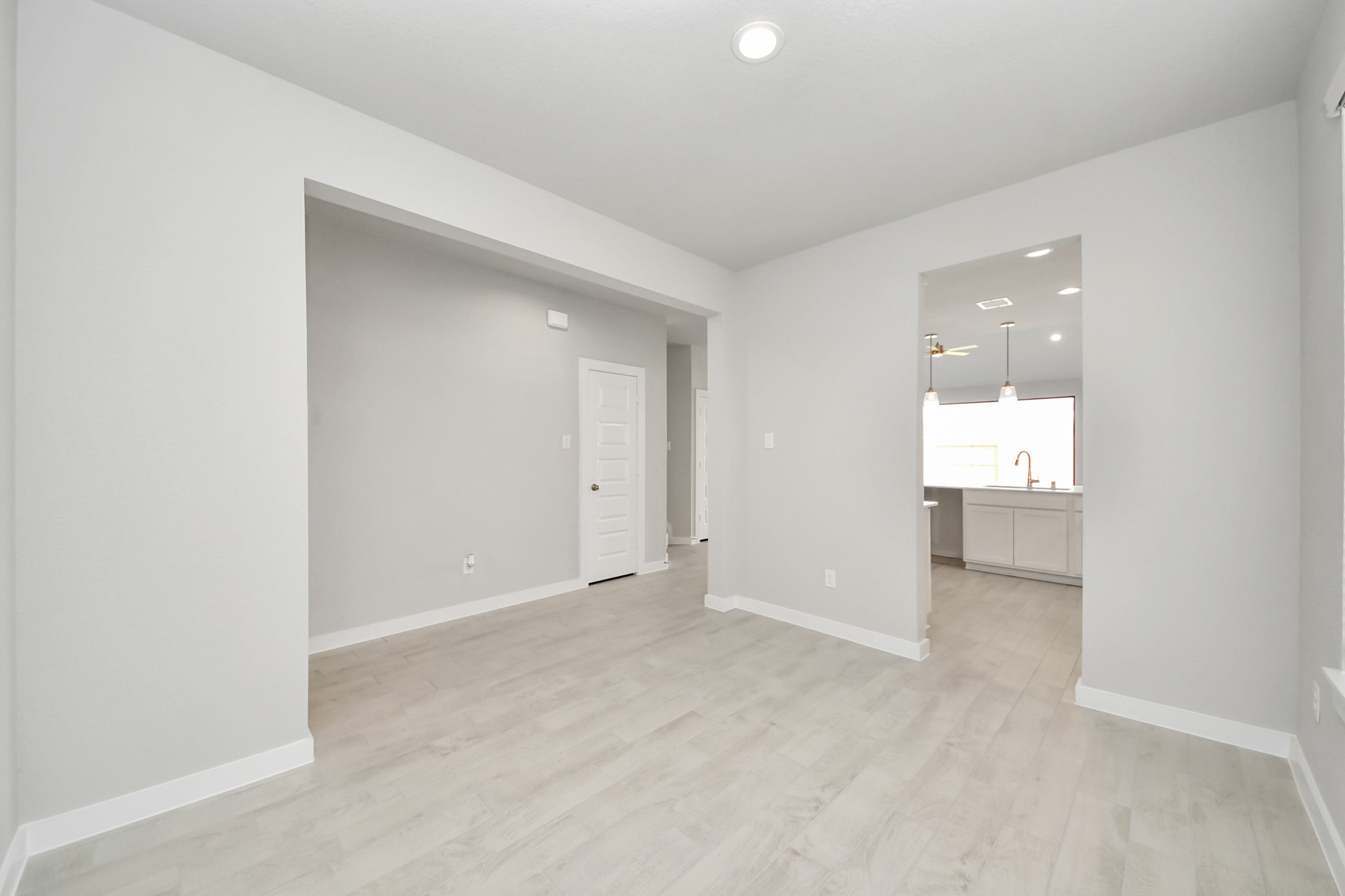 Make memories gathered around the table with your family and friends! This spacious dining room features elegant flooring, custom paint, and adjacent to family room and kitchen for open concept feel. Sample photo of completed home with similar floor plan. Actual colors and selections may vary.