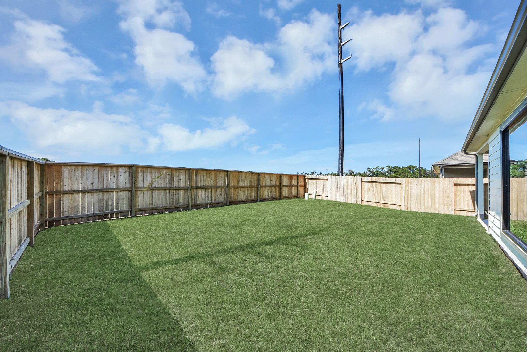 Discover the expansive backyard and its inviting covered patio  a perfect haven for both playtime for the kids and relaxation for adults. This outdoor space is an ideal canvas for your outdoor living dreams, complete with room for patio furniture, a BBQ pit, and endless possibilities for creating your own personalized oasis. Note: sample product photo. Actual exterior and interior selections may vary by homesite.