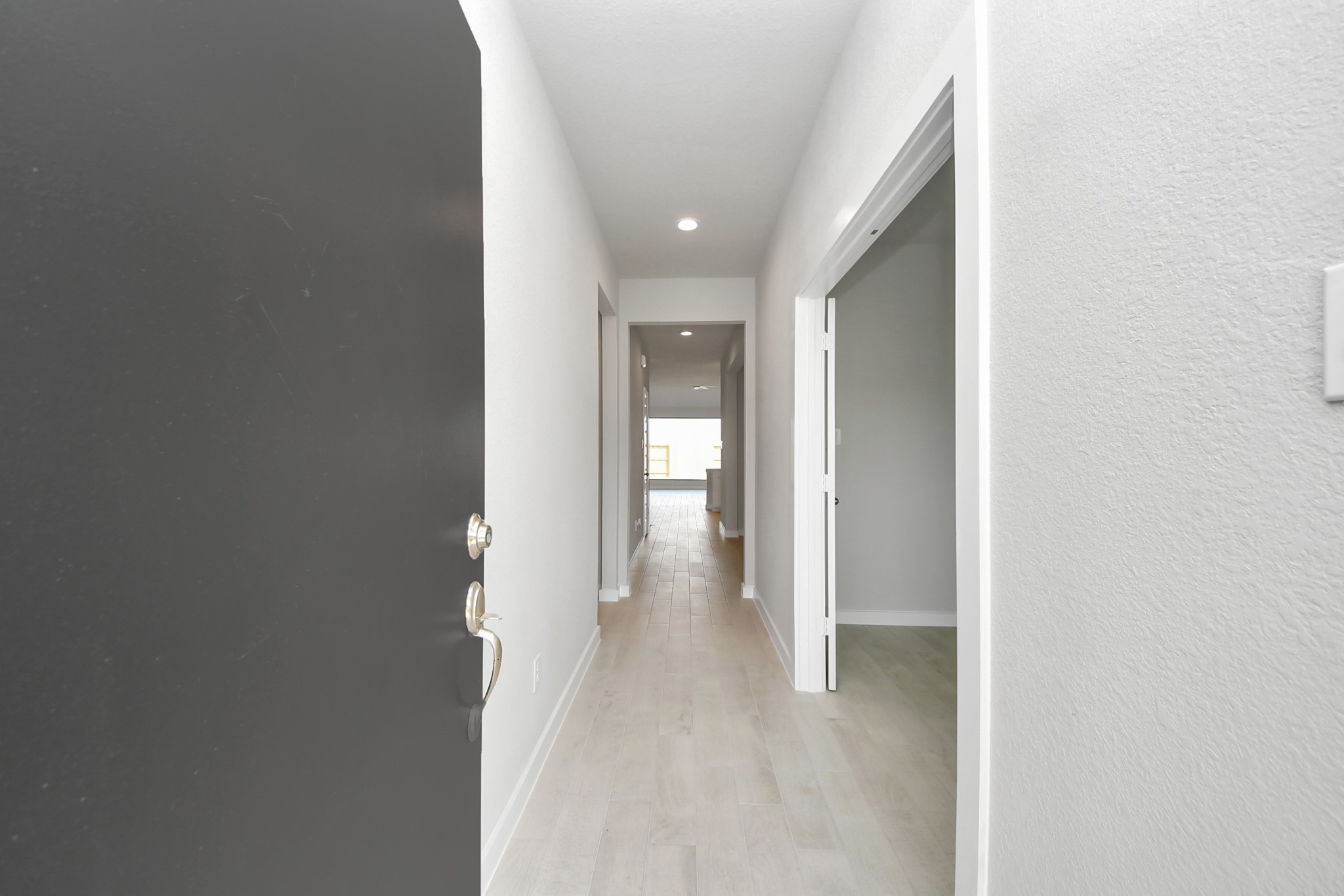 As you step into the threshold of this luxurious home, you'll soon be welcomed by an elegant glass door (to be installed). Inside, soaring ceilings amplify the spaciousness, while the refined wood-look tile flooring and oversized baseboards exude sophistication and charm. Sample photo of completed home with similar floor plan. Actual colors and selections may vary.