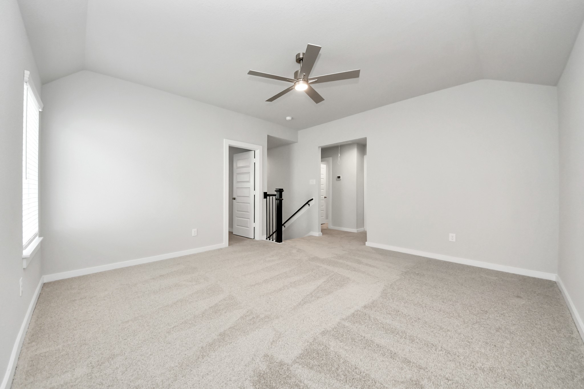Ascend to relaxation in this fantastic game room! Ideal for both casual gatherings and adult gaming, it boasts plush carpet, lofty ceilings, custom paint, and ample windows for abundant natural light. Sample photo of completed home with similar floor plan. Actual colors and selections may vary.