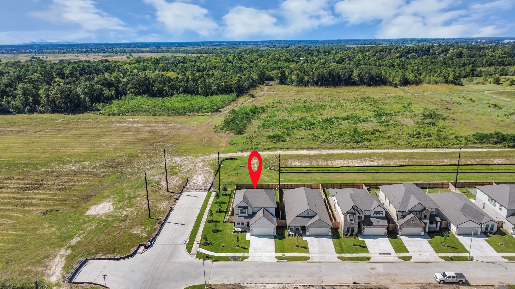 An aerial view of a spacious subdivision lot, highlighting a well-maintained yard and a fully fenced perimeter, offering both privacy and expansive outdoor space.