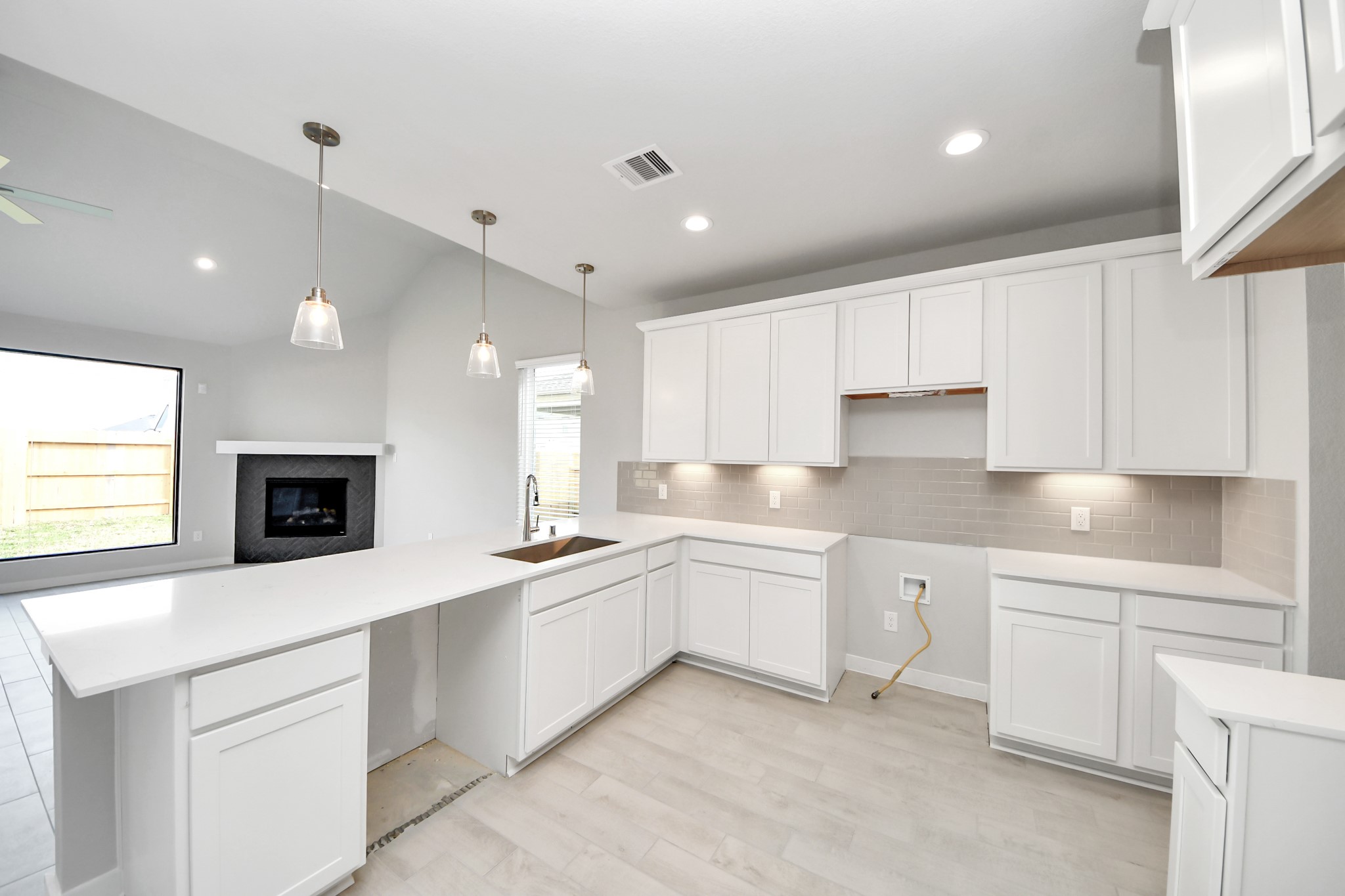 All of this overlooks your expansive family room, creating a perfect space for culinary delights and family gatherings. Sample photo of completed home with similar floor plan. Actual colors and selections may vary.