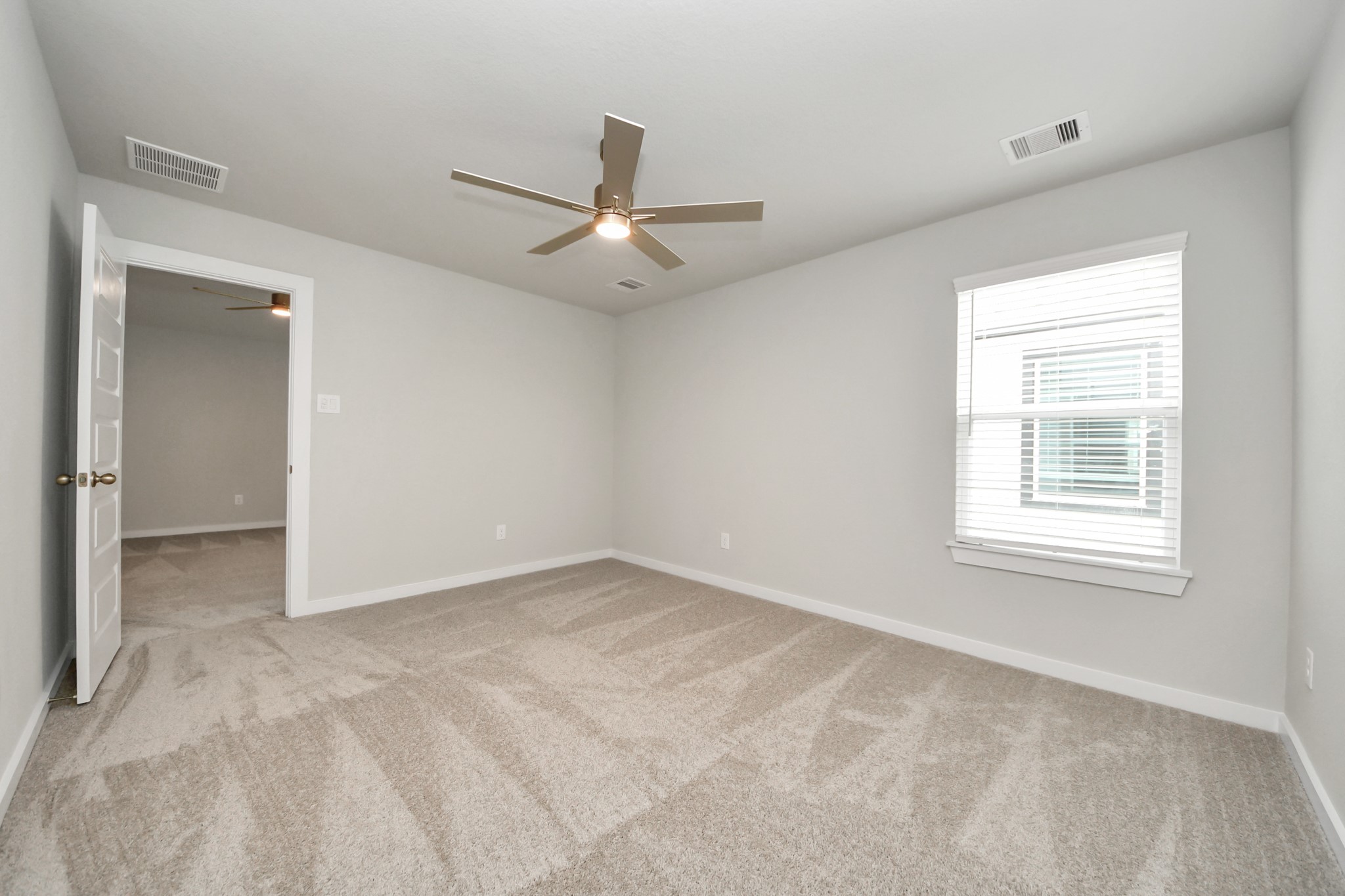 Generously sized secondary bedrooms featuring spacious closets, soft and inviting carpeting underfoot, large windows allowing plenty of natural light, and the added touch of privacy blinds for your personal retreat. Sample photo of completed home with similar floor plan. Actual colors and selections may vary.