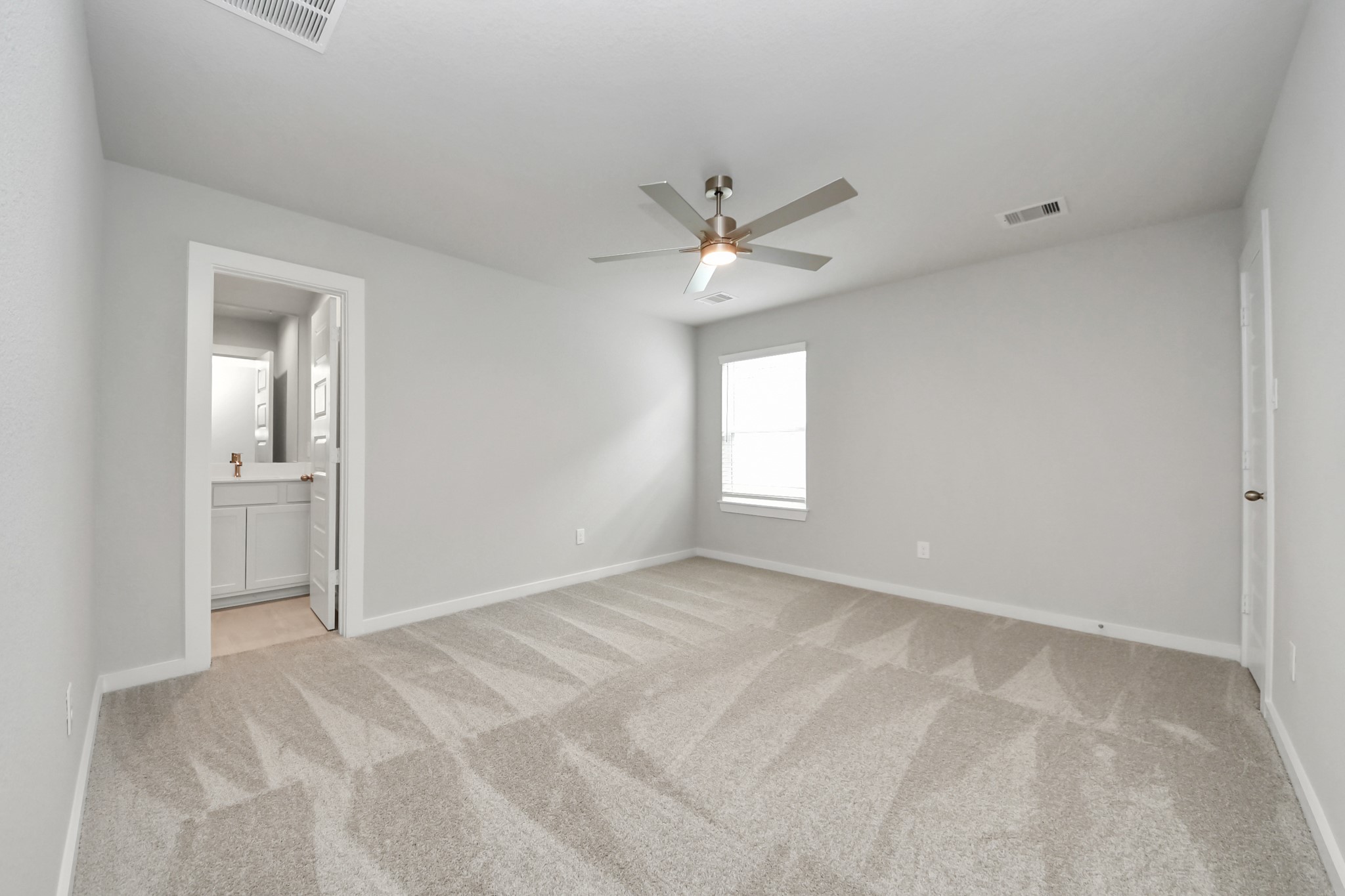 Secondary bedroom features plush carpeting, large windows that let in plenty of natural light, bright paint, and spacious closets. Sample photo of completed home with similar floor plan. Actual colors and selections may vary.