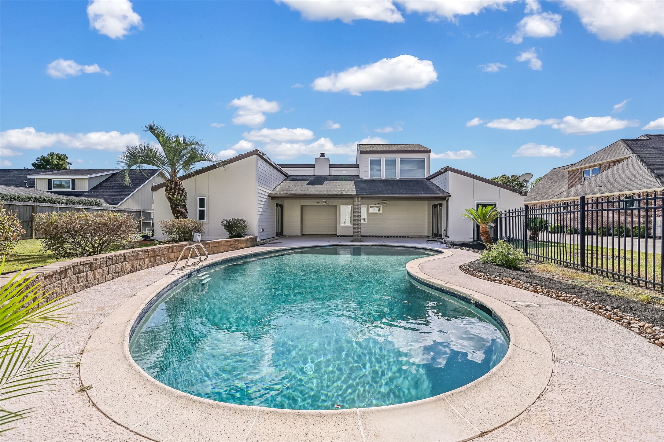 Enjoy your own backyard retreat with a sparkling swimming pool, expansive decking & a large covered patio with ceiling fans! The primary bedroom offers direct patio access, while mature landscaping & a fenced pool area create an inviting setting for relaxing or entertaining outdoors.