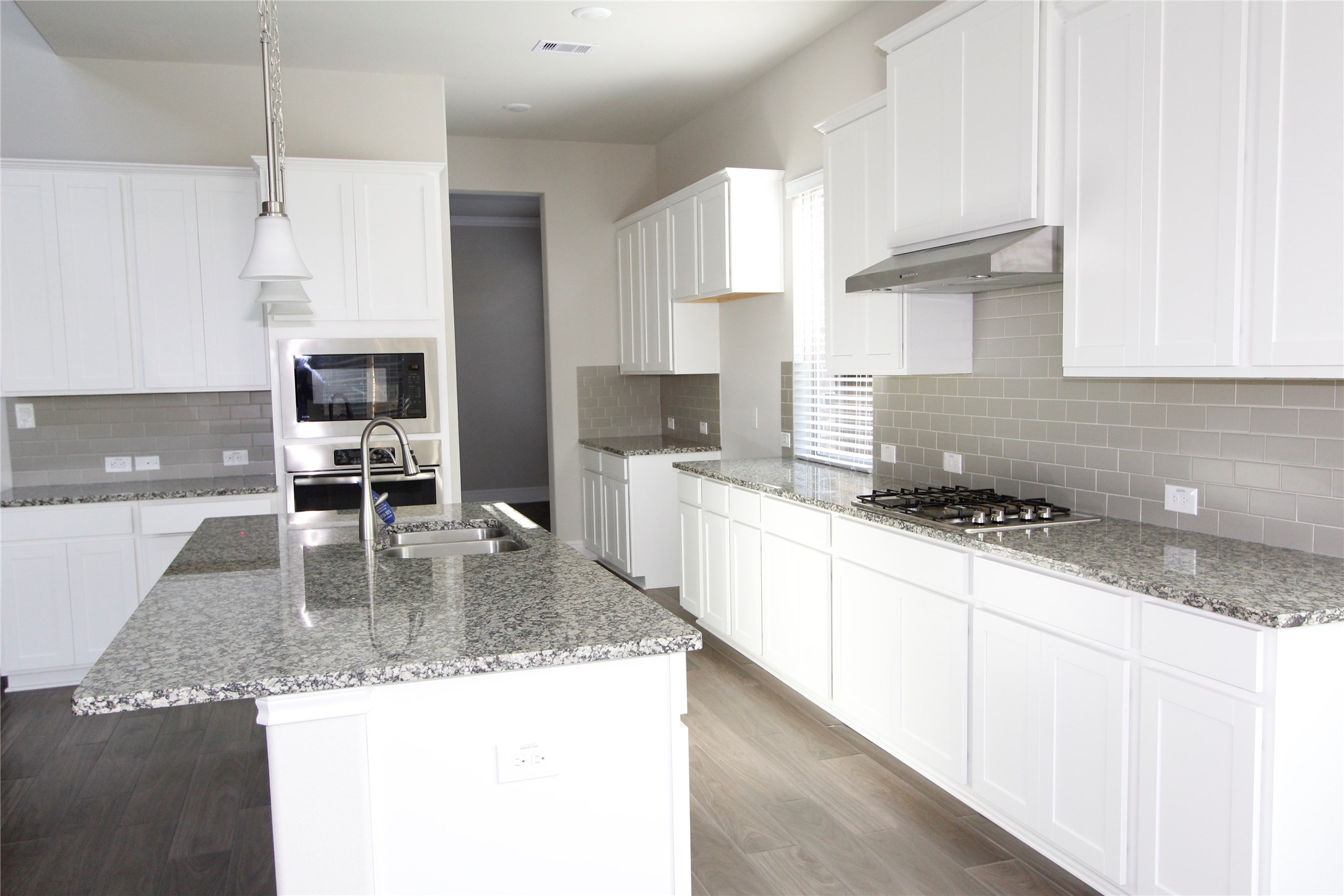 Open kitchen concept with a spectacular matching countertop, cabinets and cooktop