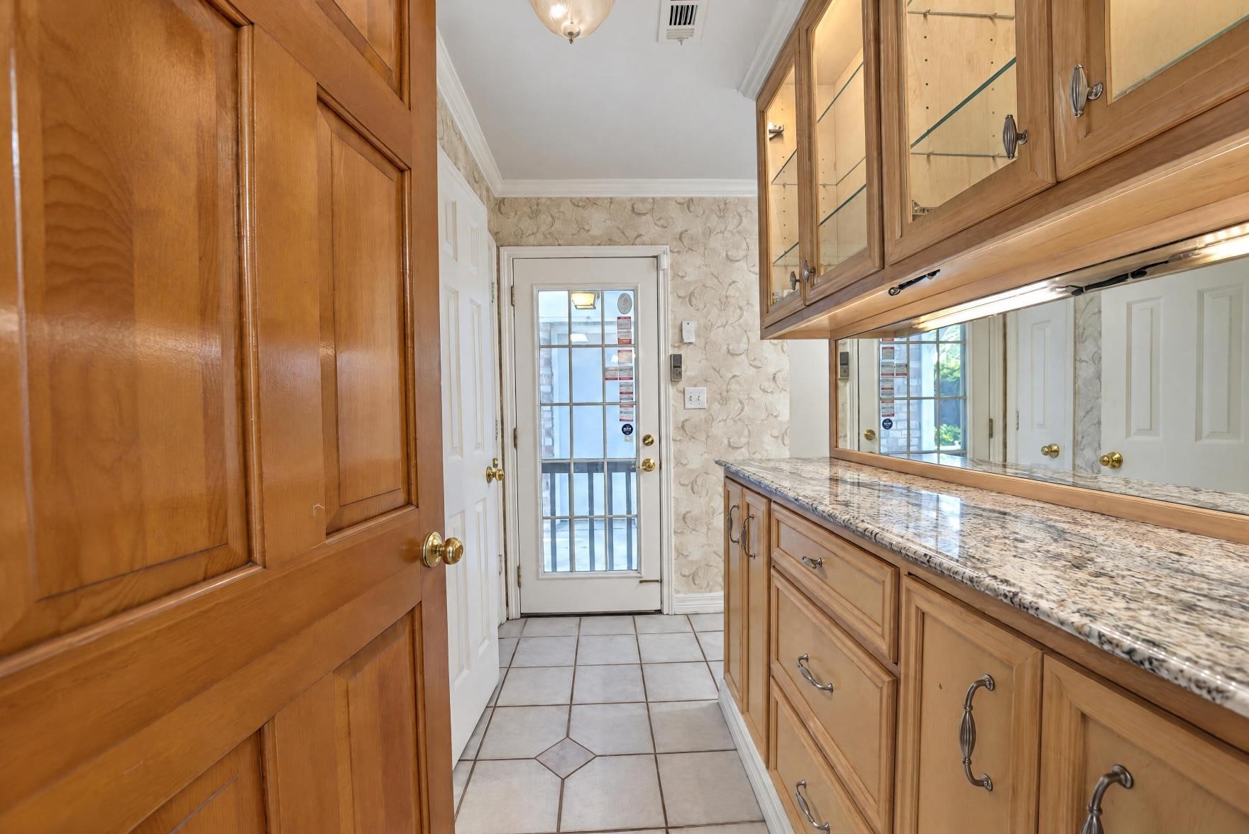 Hallway leading to the powder room and the utility room