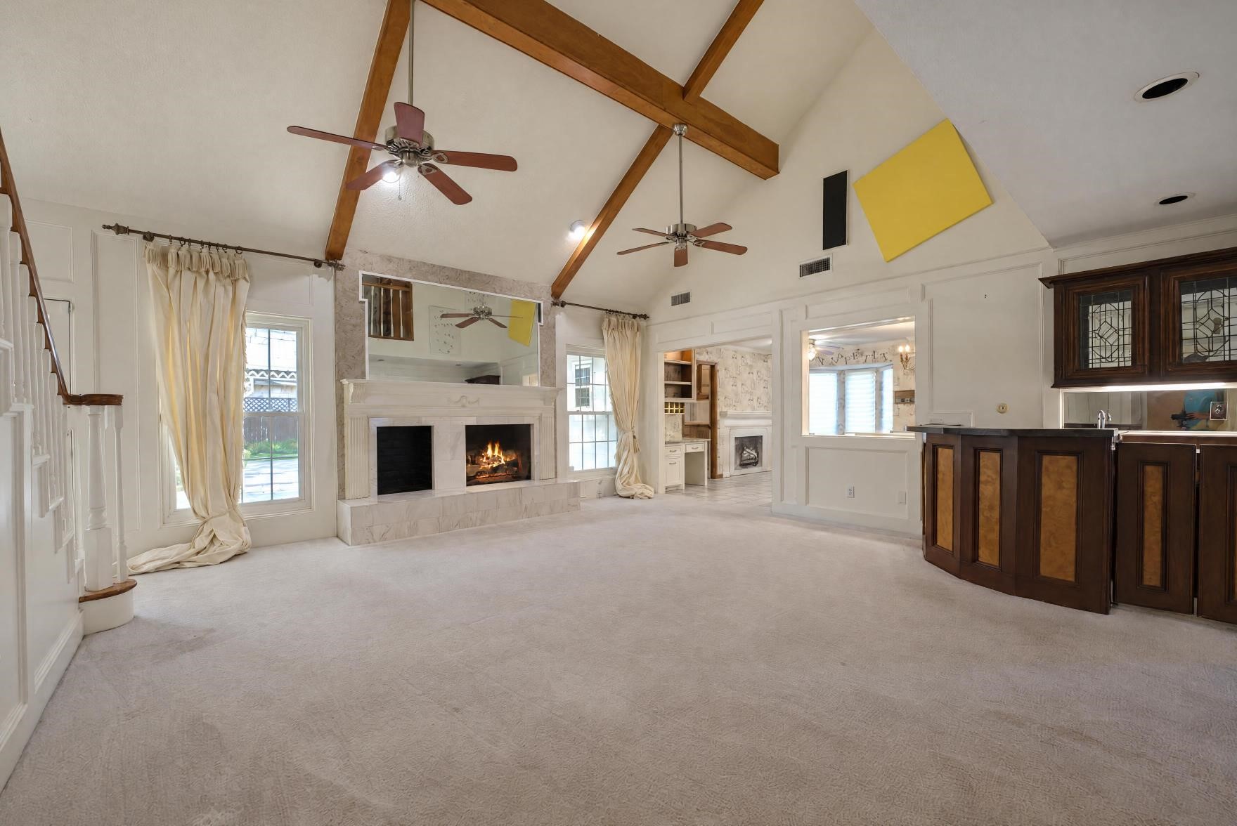 The large family room with gas log fireplace, and a wet bar.