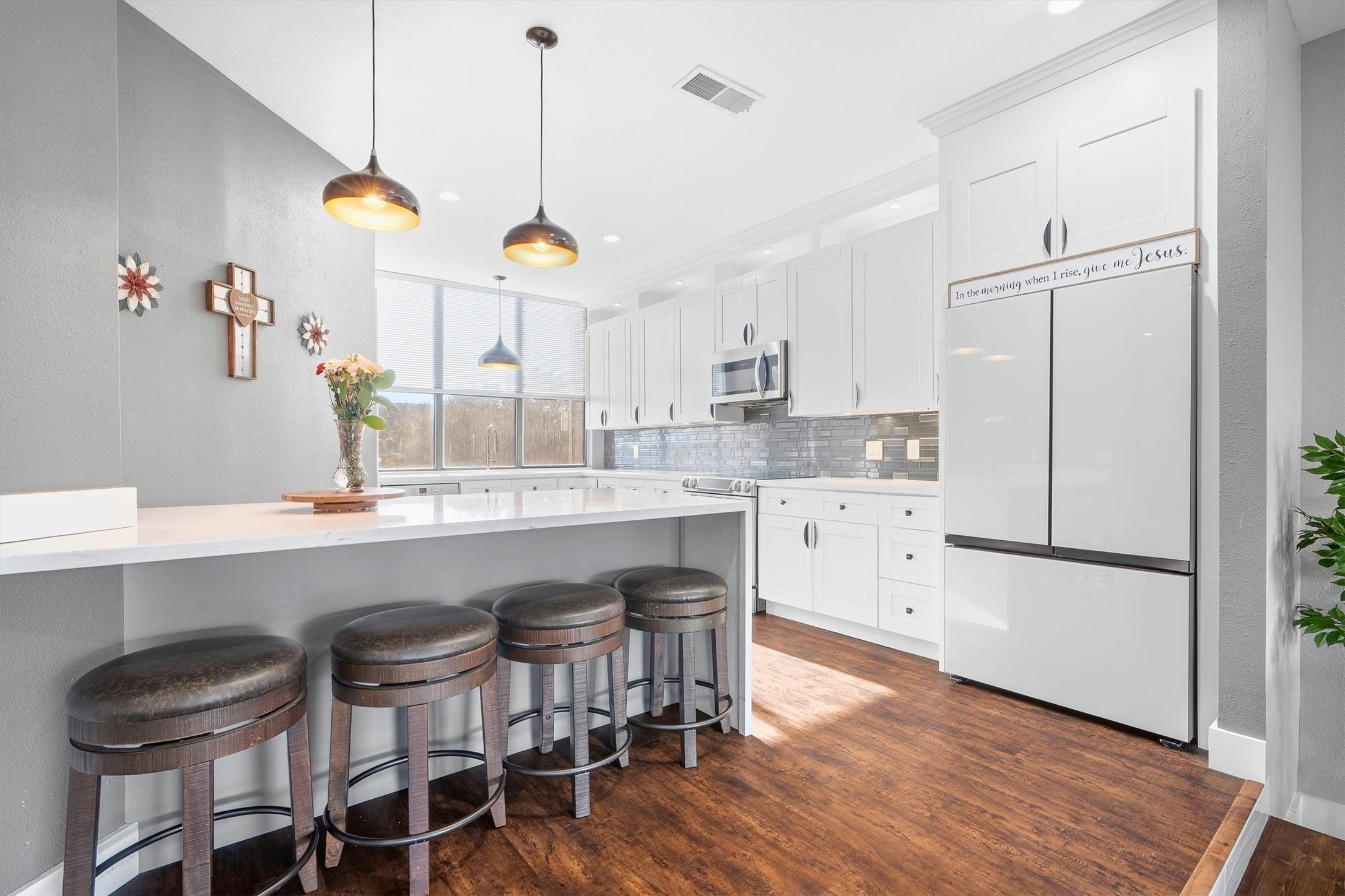 Kitchen features additional barstool seating.