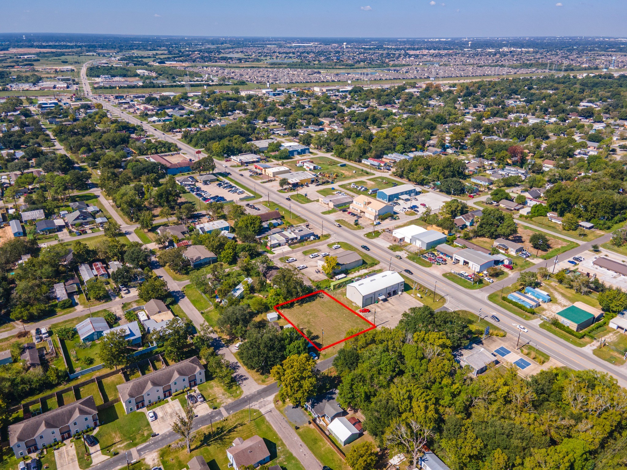 Wider aerial view showing the lot and surrounding roads and neighborhood. Wider aerial view showing the lot and surrounding roads and neighborhood.