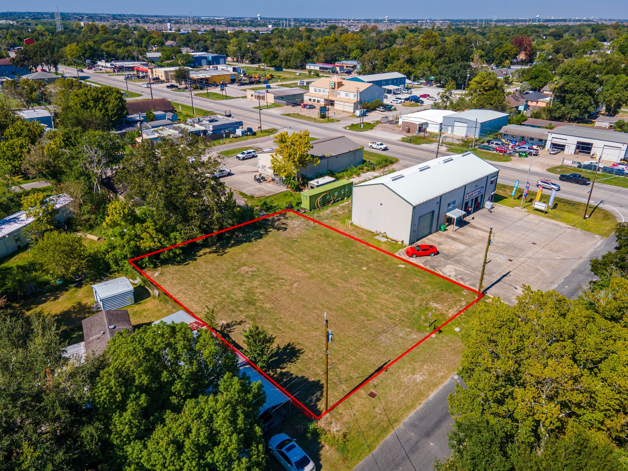Aerial view of the open lot with approximate boundaries outlined in red. Aerial view of the open lot with approximate boundaries outlined in red.