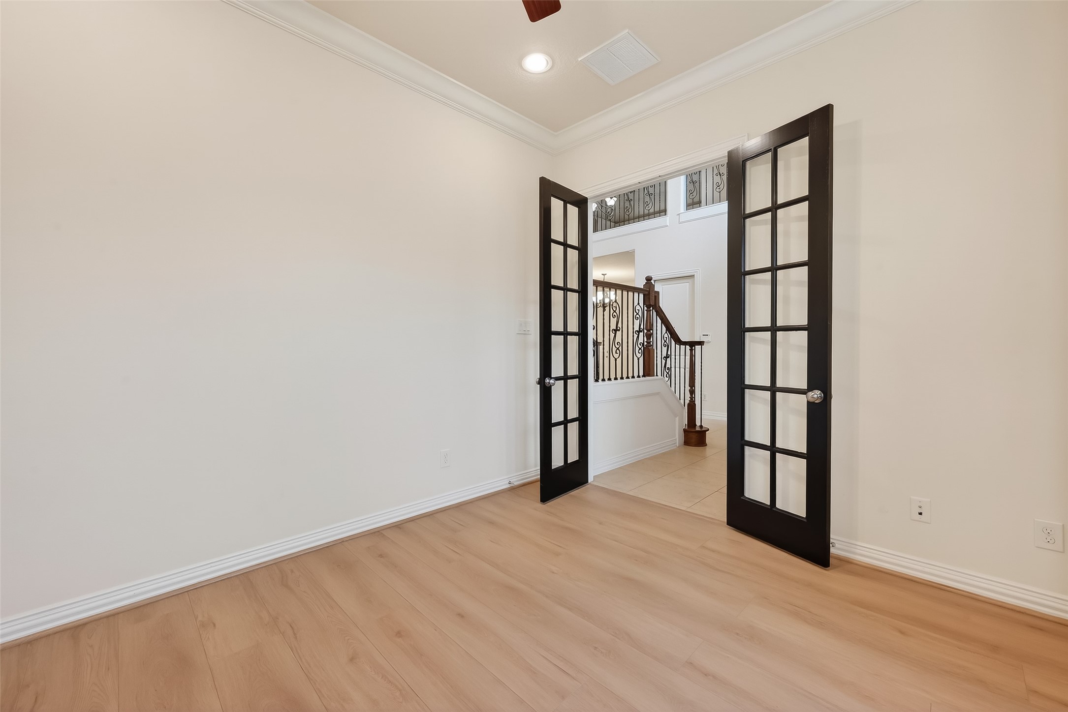 Fabulous Private Study offers French double doors for privacy, wood flooring and freshly painted walls.