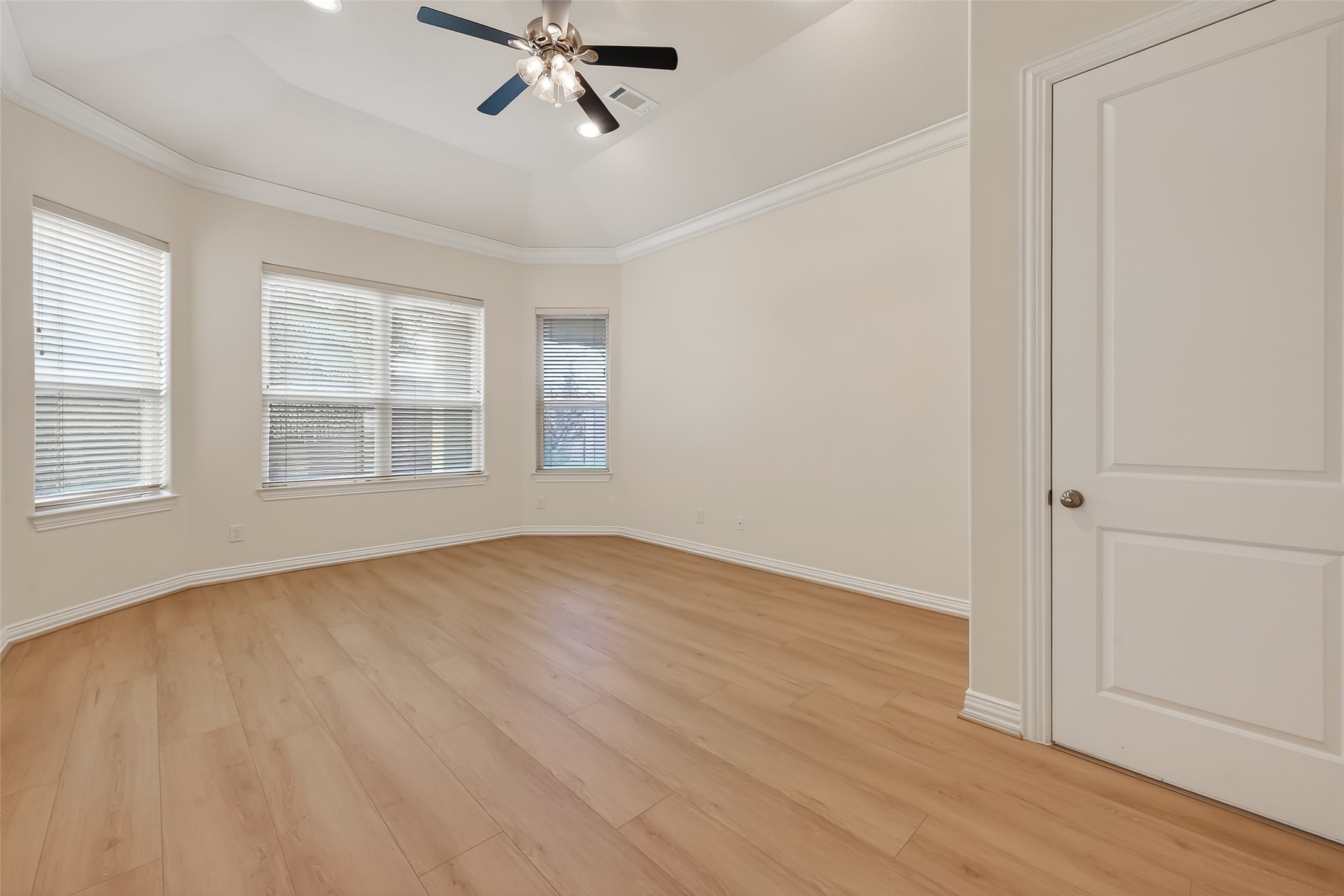 Primary Bedroom overlooks backyard.