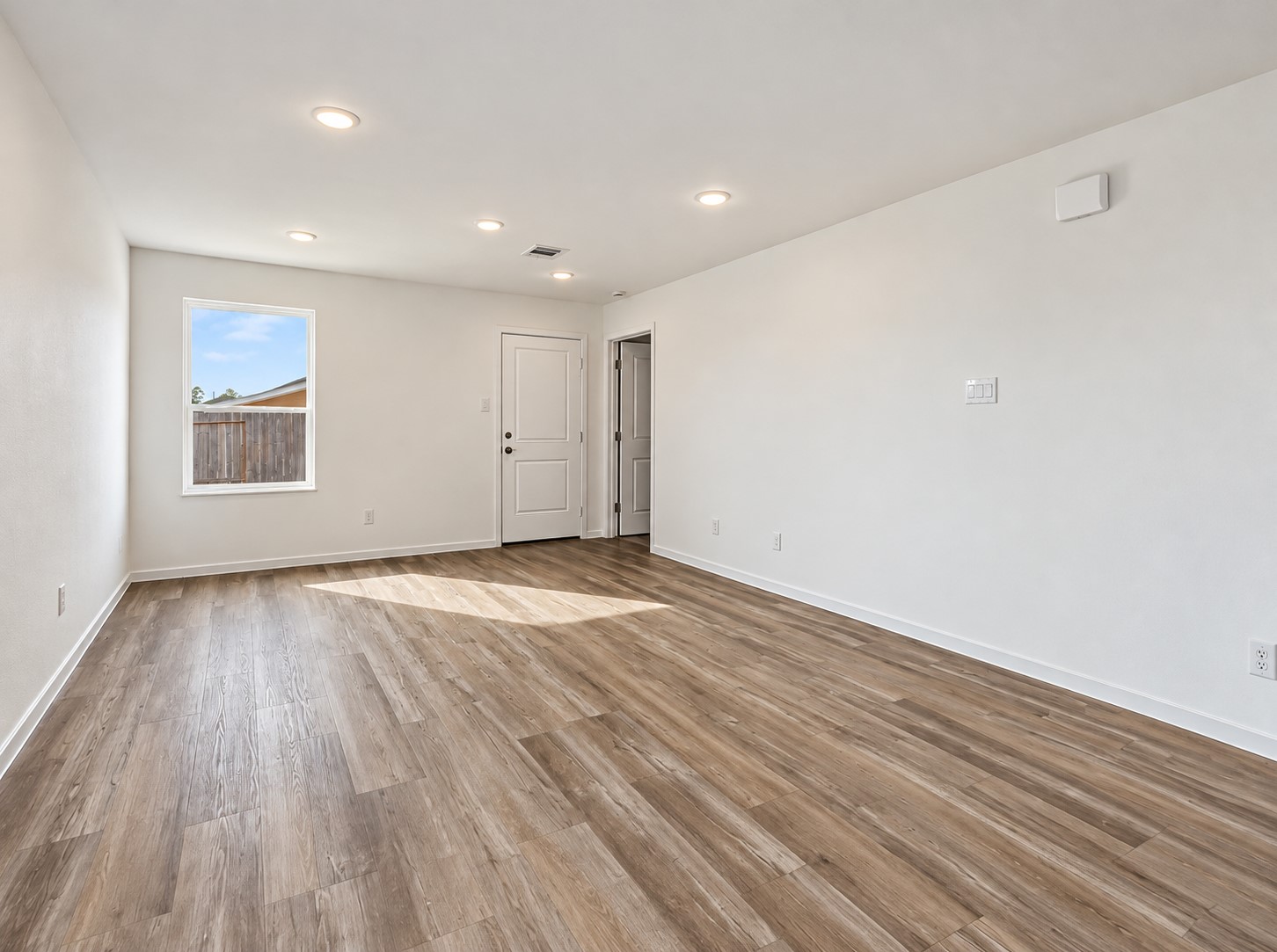 The spacious and bright living room flows seamlessly into the kitchen and dining areas.