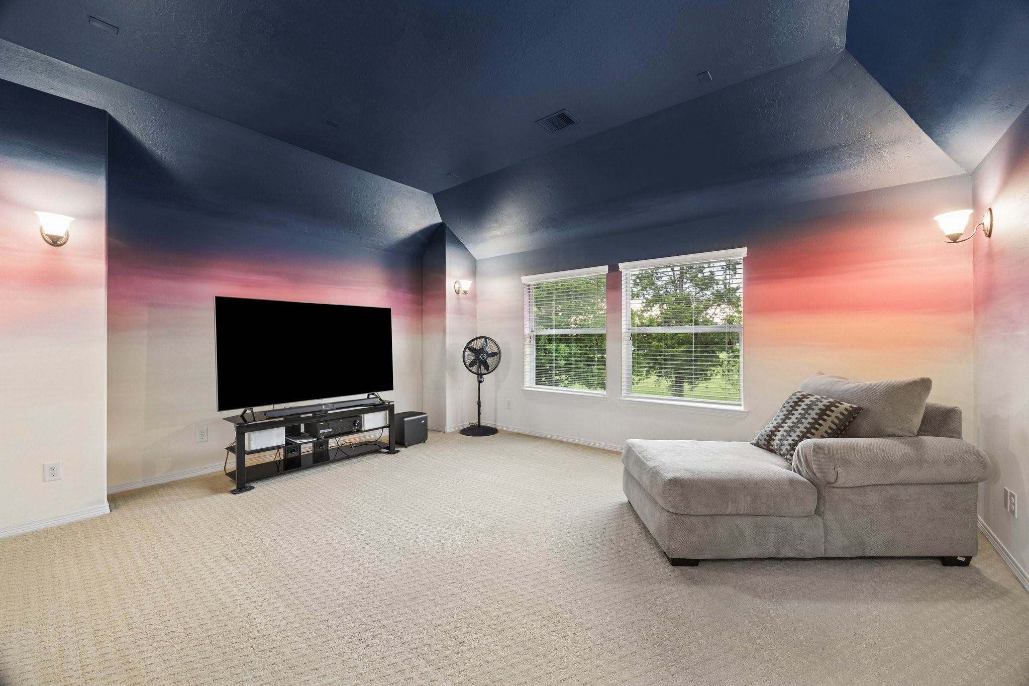 A generously sized upstairs media room wired for projector and surround sound offers a versatile space for entertainment and relaxation.