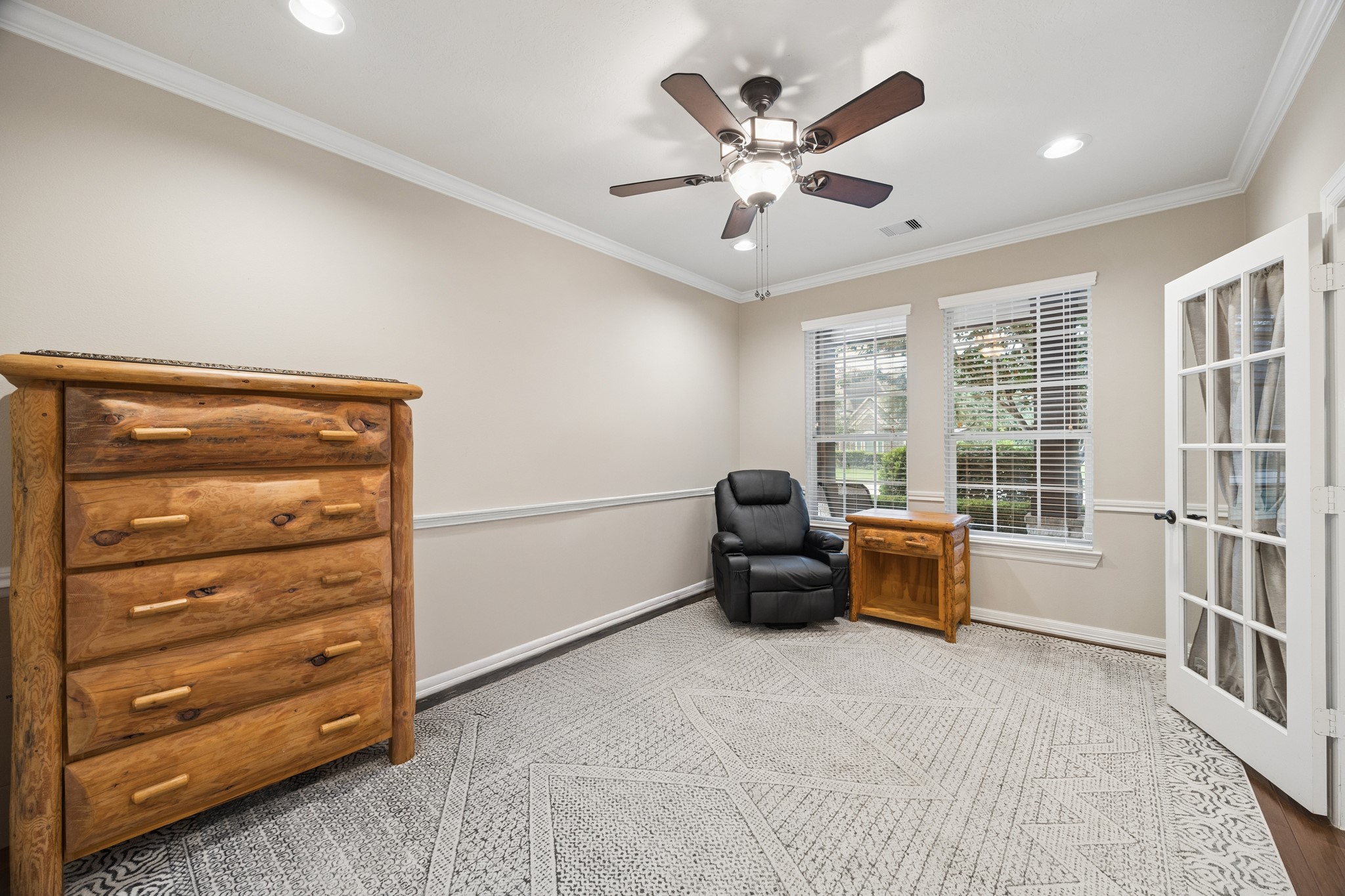 Designed with versatility in mind, this spacious first floor room with a closet is perfect as a home office, study, secondary living area, or extra bedroom. Elegant French doors, refined crown molding, and plentiful natural light enhance its inviting atmosphere.