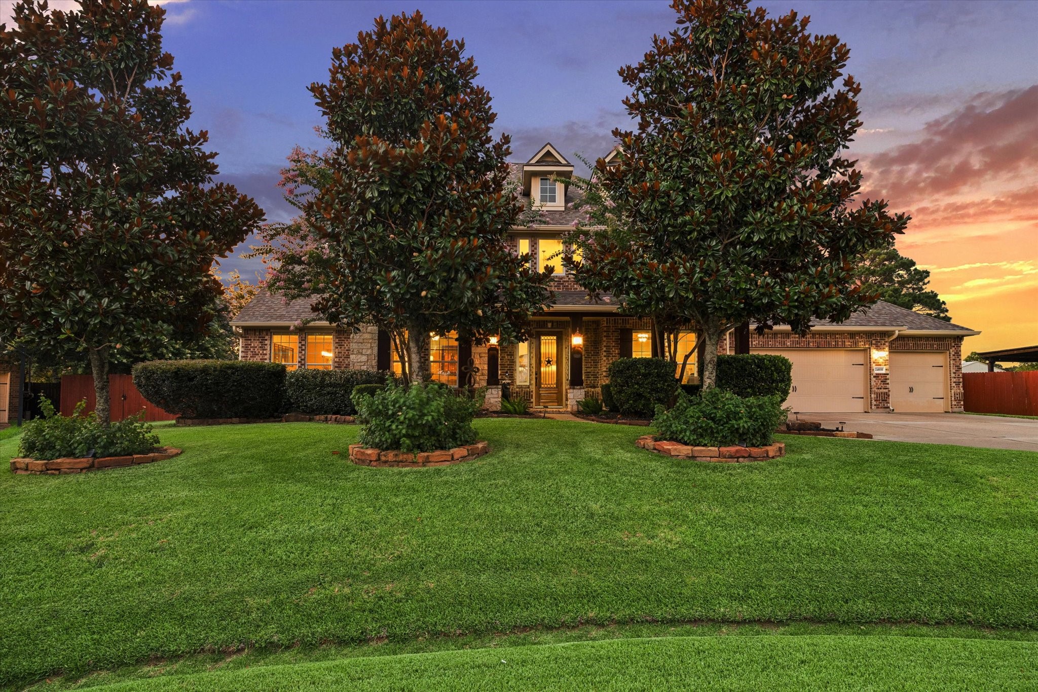 A captivating first impression of this exceptional 5,783-square-foot residence, where timeless architecture, mature landscaping, and lush surroundings come together to create a warm and elegant welcome.