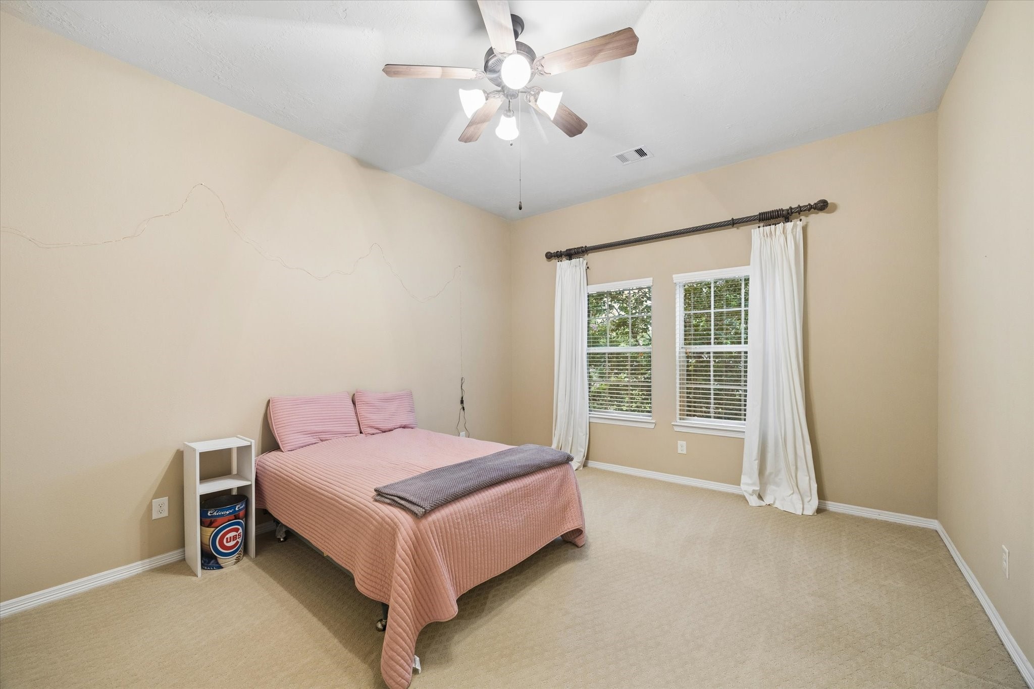 Inviting secondary bedroom offering a comfortable layout, high ceilings, and an abundance of natural light.