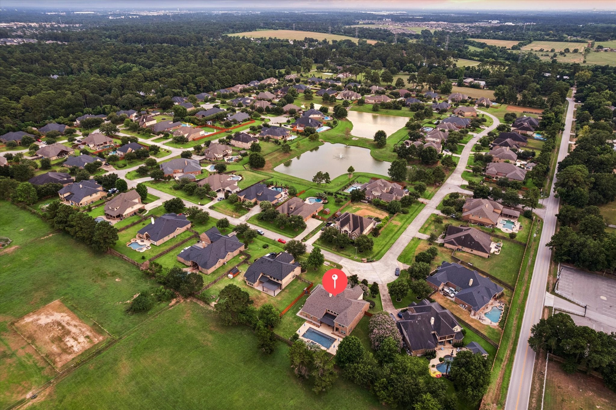 This impressive aerial view highlights the propertys desirable cul-de-sac location and expansive backyard, offering exceptional space for outdoor living and entertaining. The resort-style pool and beautifully designed backyard create a private retreat, while the nearby community lake, just a short walk from the home, adds to the peaceful and relaxing atmosphere of Waterstone Estates.