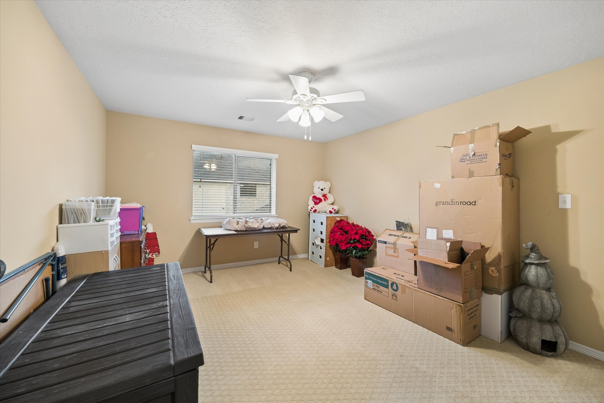 Filled with natural light, this generously sized secondary bedroom currently used as storage offers a comfortable and inviting retreat.