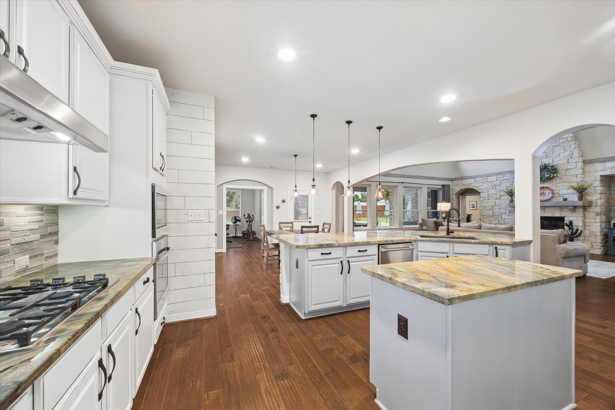 The spacious kitchen offers an abundance of cabinetry and generous counter space, thoughtfully designed for both everyday living and entertaining. Its open layout creates a seamless connection to the breakfast area and family room, allowing the homes impressive spaces to flow together beautifully.
