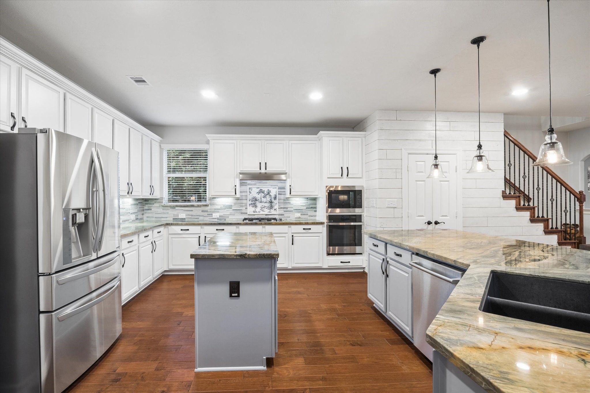 At the heart of the home, this spacious kitchen blends style and functionality with abundant cabinetry, expansive countertops, stainless steel appliances, and generous prep space. Its open design flows seamlessly into the family and breakfast areas, creating an inviting setting for everyday living and entertaining.