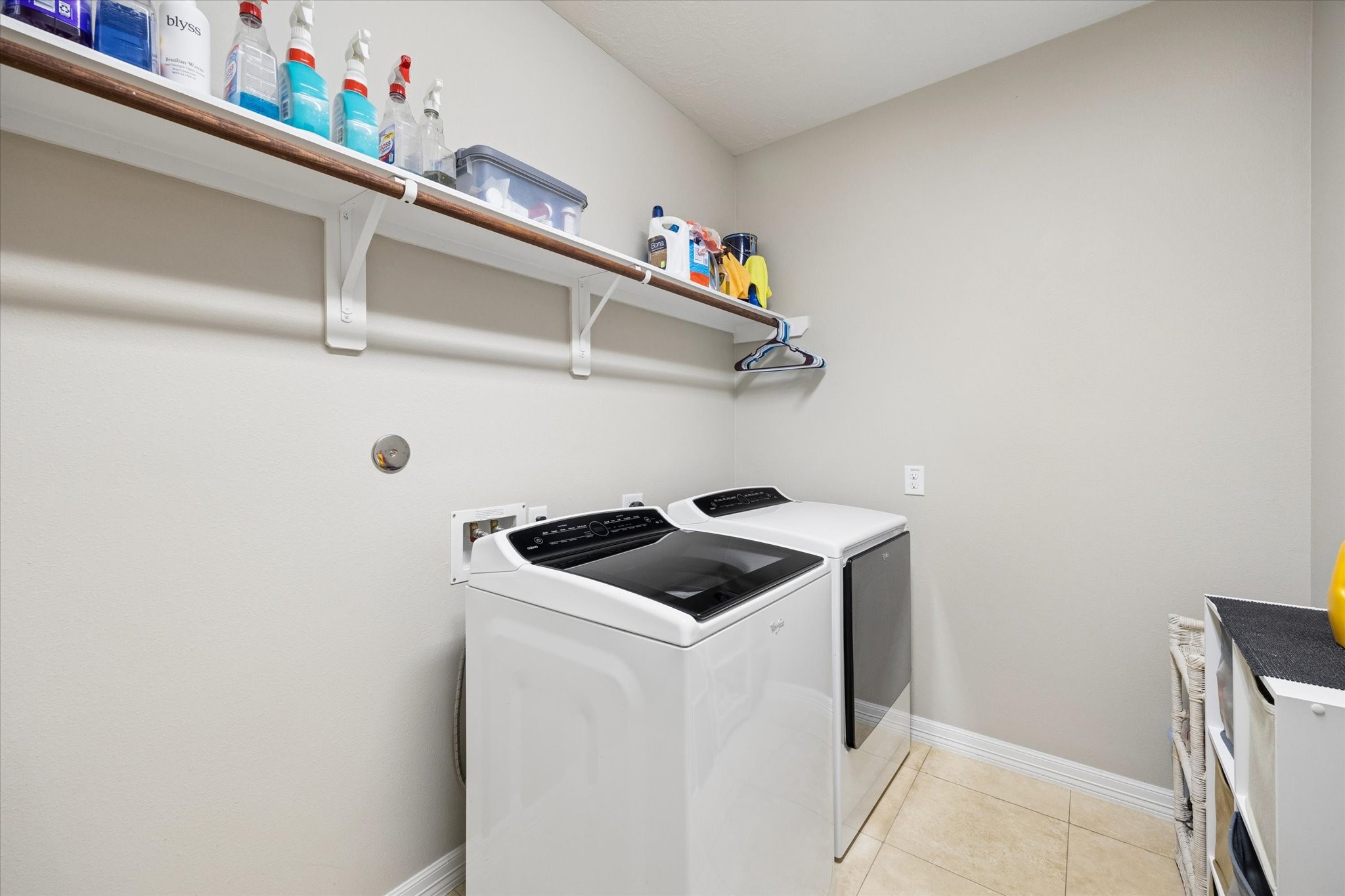 Well-appointed laundry room offering generous space and practical storage for added everyday convenience.