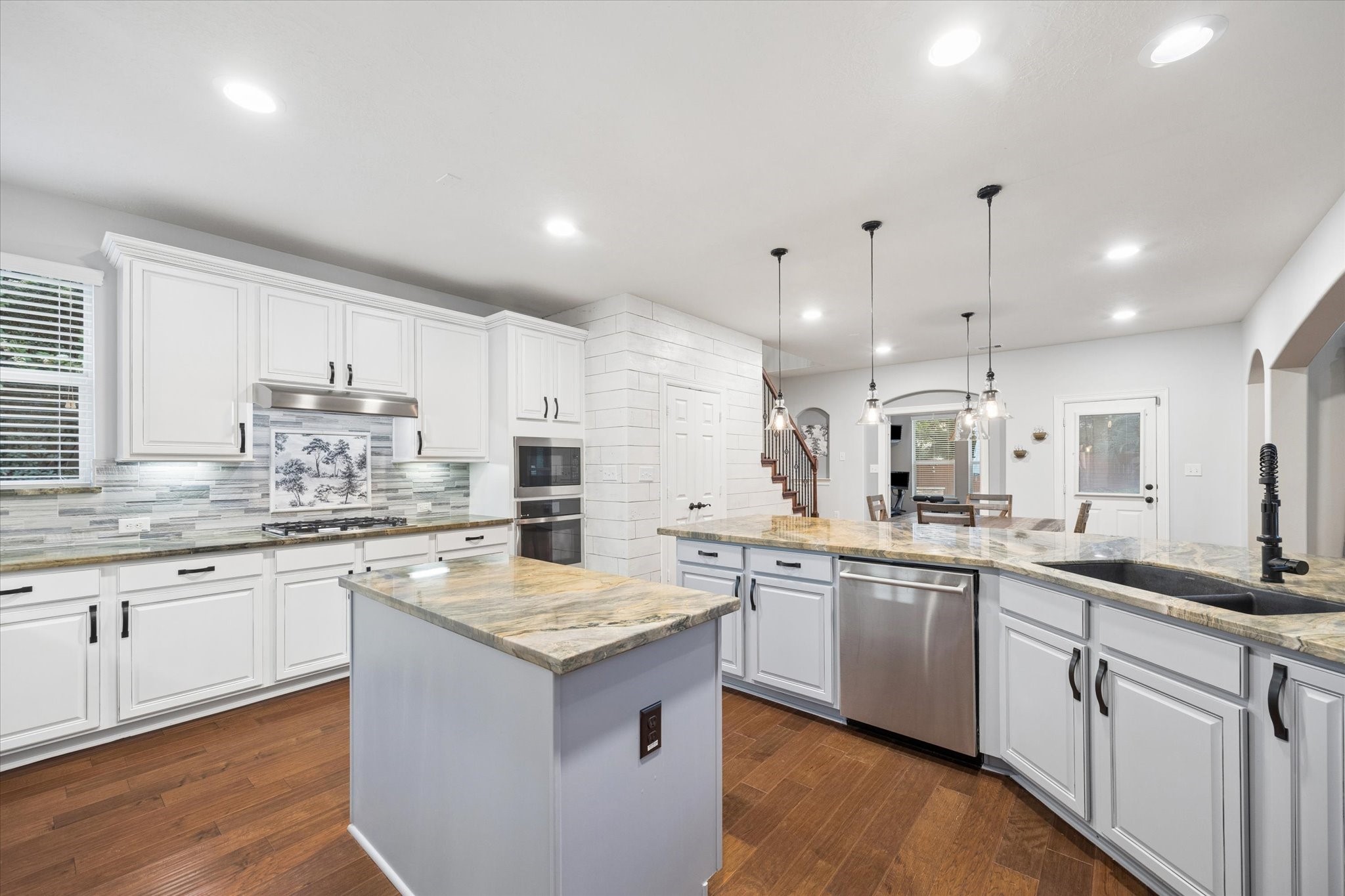 A closer look at the beautifully appointed kitchen highlights expansive countertops, abundant cabinetry, stainless steel appliances, and generous prep space. Thoughtfully designed for both functionality and style, this inviting space makes everyday cooking and entertaining effortless.