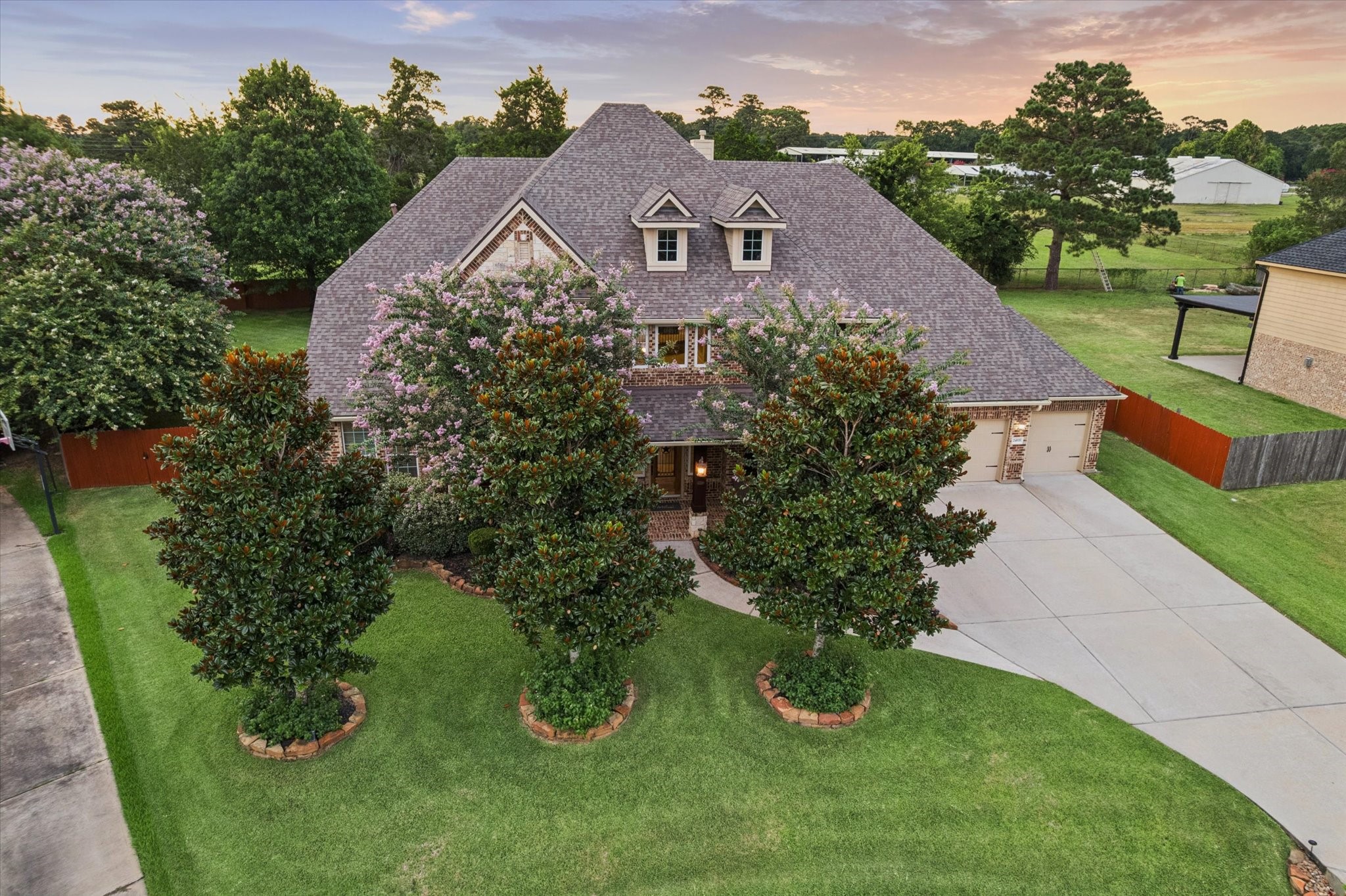 This impressive aerial view highlights the homes desirable location within the beautiful Waterstone Estates community. Surrounded by spacious homesites, scenic lakes, and peaceful surroundings, this exceptional property offers the perfect setting to enjoy the lifestyle and charm of this sought-after community.
