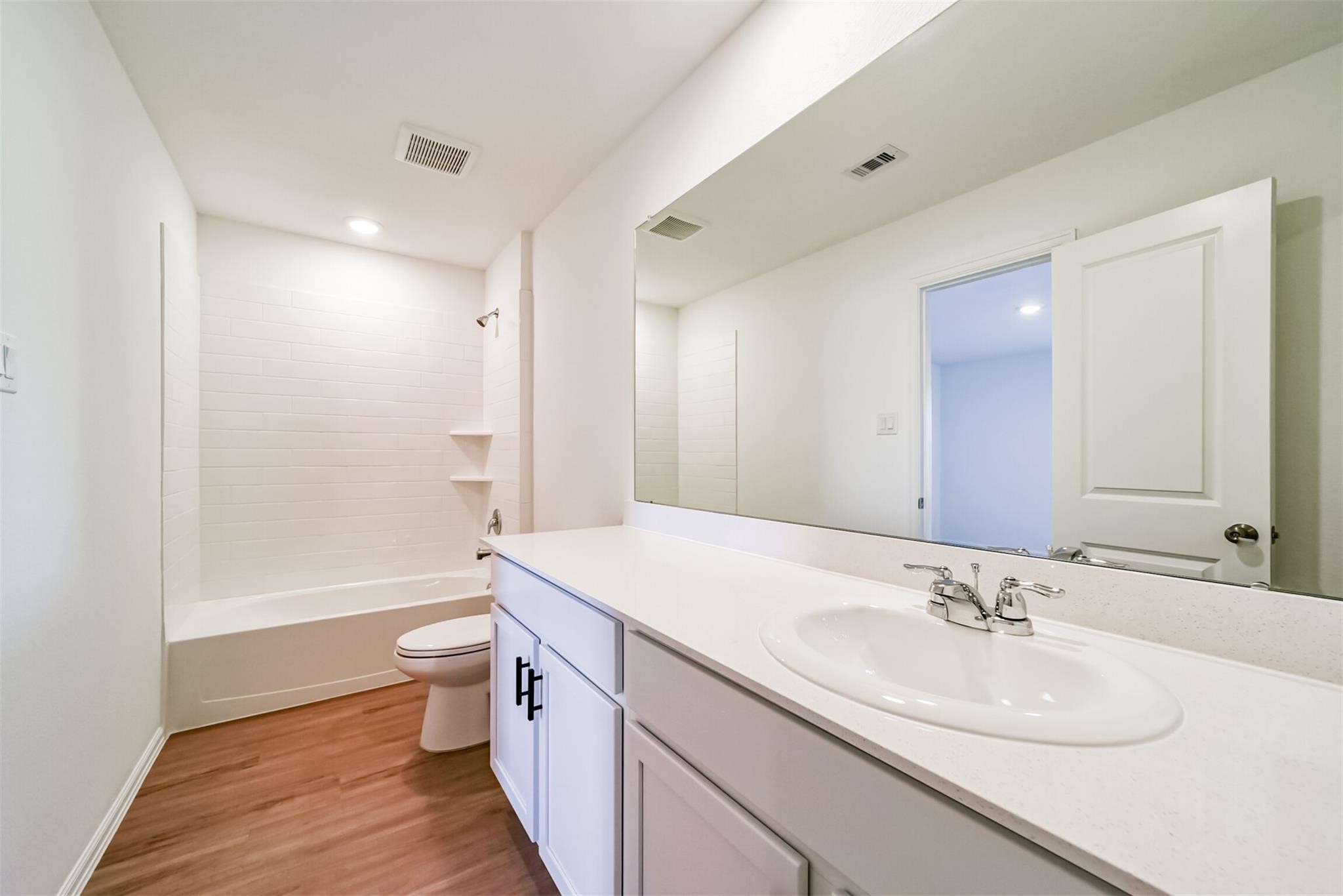 primary bathroom featuring a relaxing soaking tub, separate shower, and a large vanity