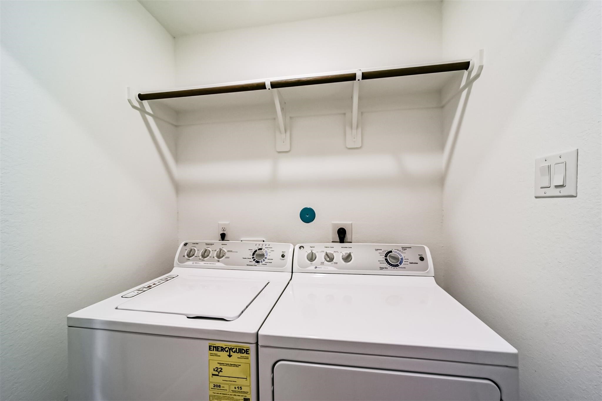 Convenient laundry room equipped with a washer and dryer, ready for you inside the house!